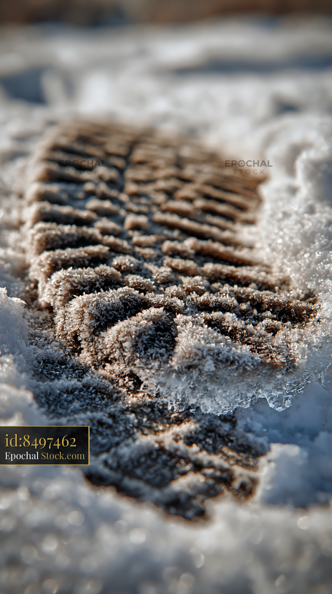 Detailed boot footprint in deep snow with frozen ice crystals - stock photo