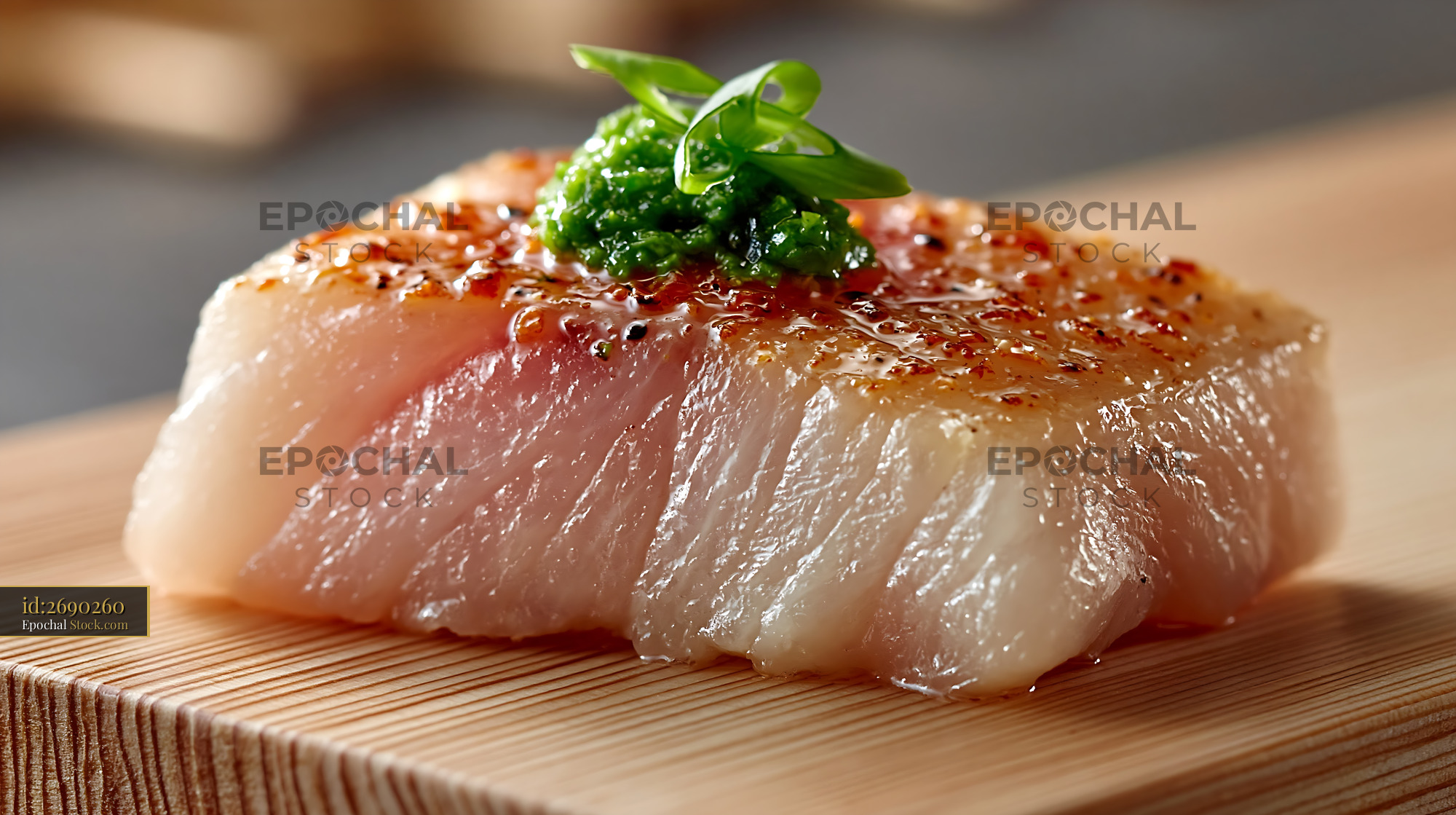 Seared yellowtail sushi with yuzu kosho on a wooden board - stock photo