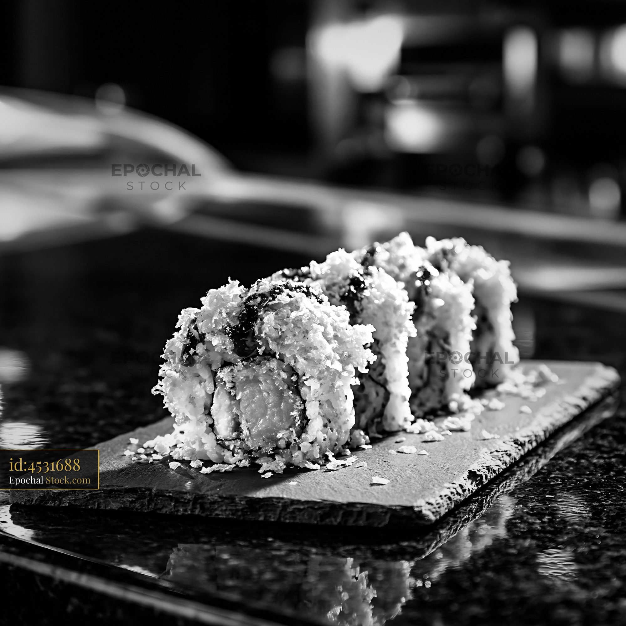 Sweet potato crunch sushi rolls on a slate board in black and white - stock photo