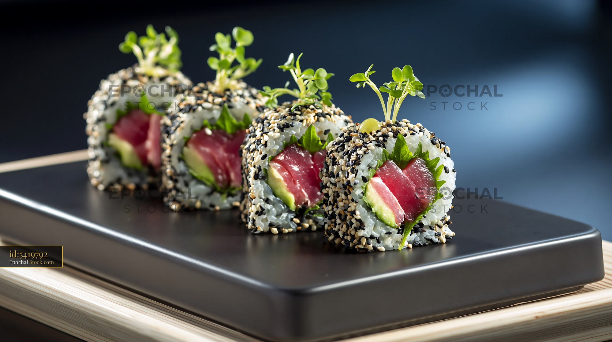 Shiso leaf uramaki sushi with tuna and avocado on a black plate - stock photo