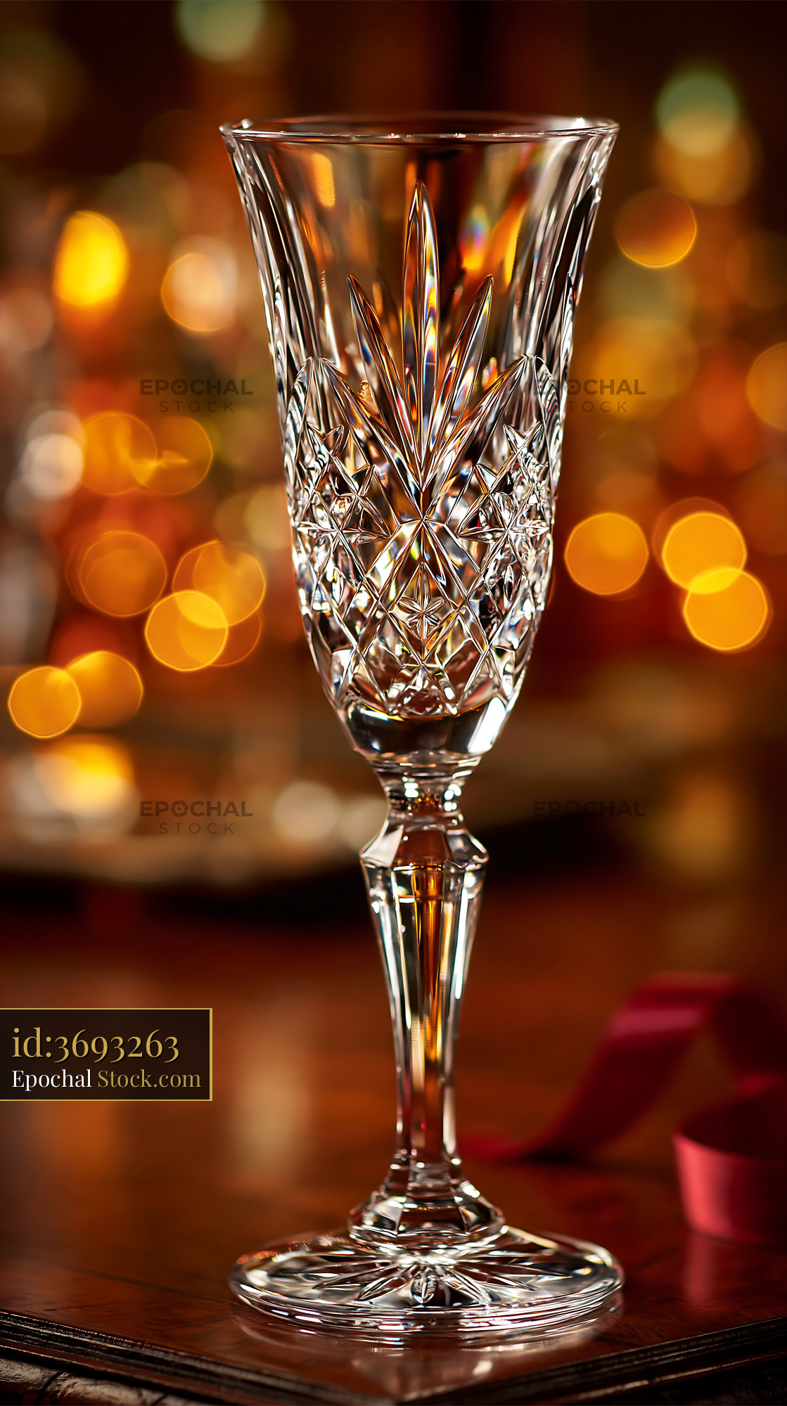 Empty crystal champagne glass on wooden table with festive bokeh - stock photo