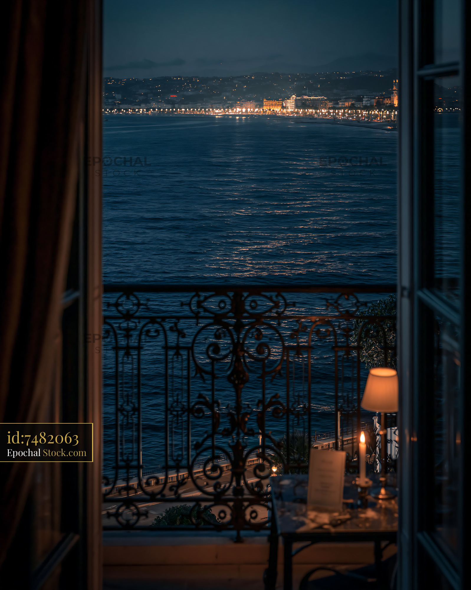 Balcony view of the Mediterranean sea and city lights at night - stock photo