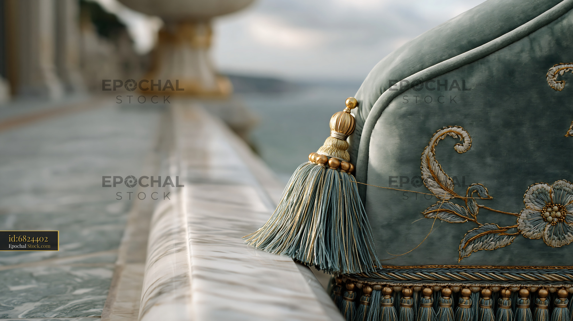 Elegant velvet cushion with gold tassel on a luxury hotel balcony - stock photo