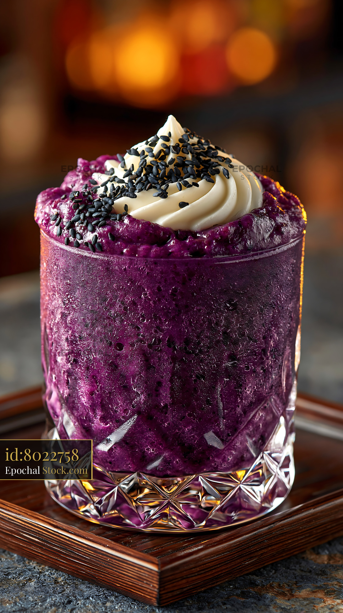 Purple sweet potato smoothie with cream swirl and black sesame seeds - stock photo