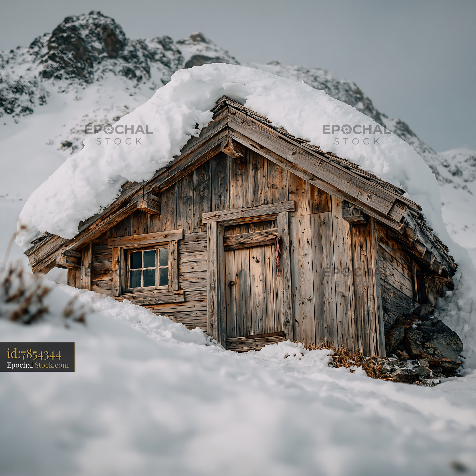 Snow covered empty cabin in the high mountains during winter - stock photo