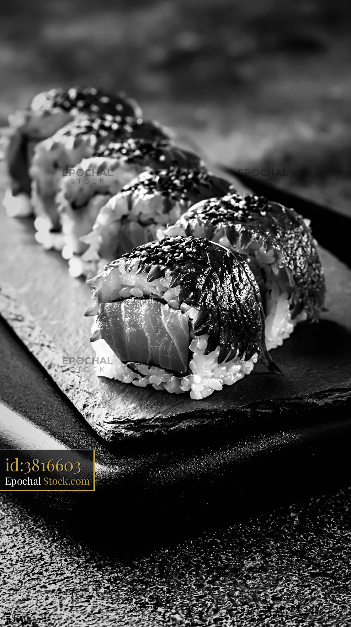 Gourmet shiso leaf uramaki sushi rolls on a slate stone plate - stock photo