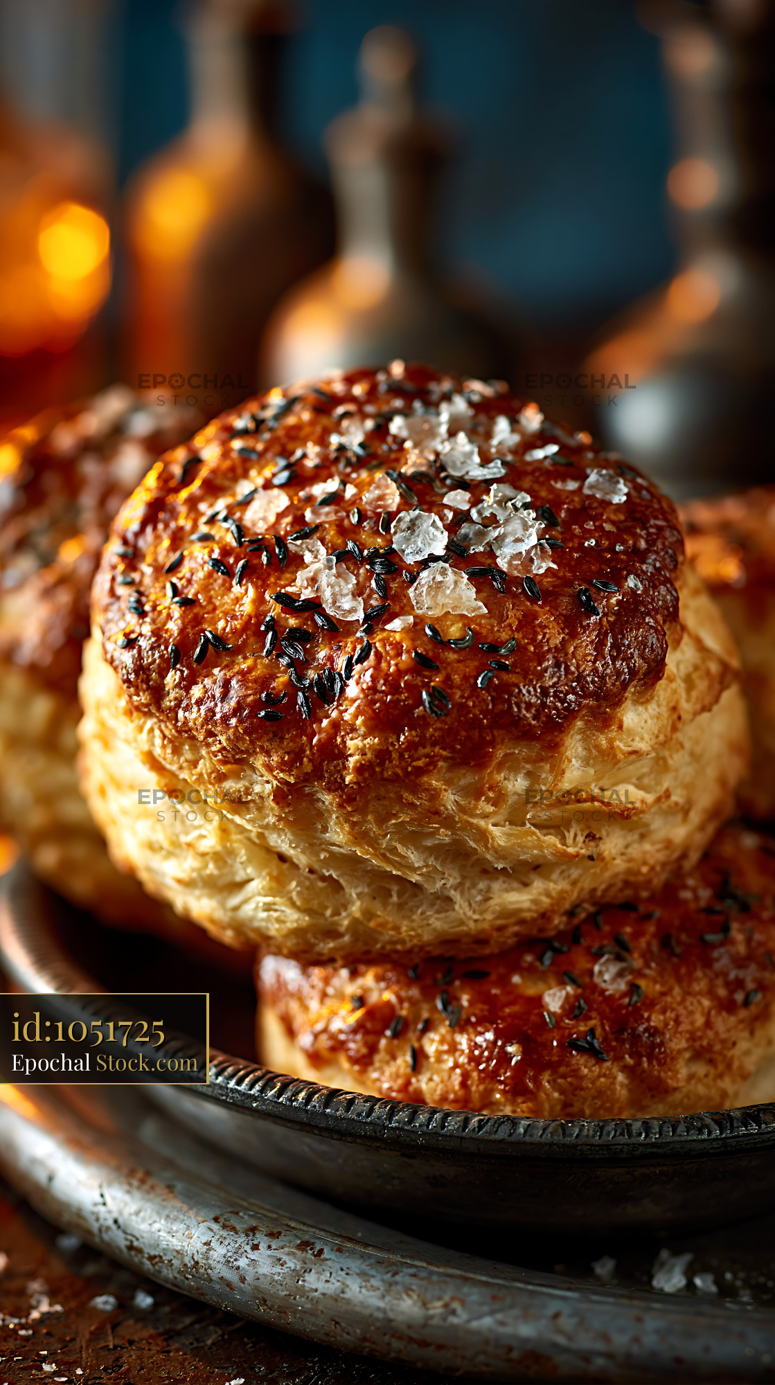Golden caraway seed biscuits with sea salt on a rustic metal plate - stock photo