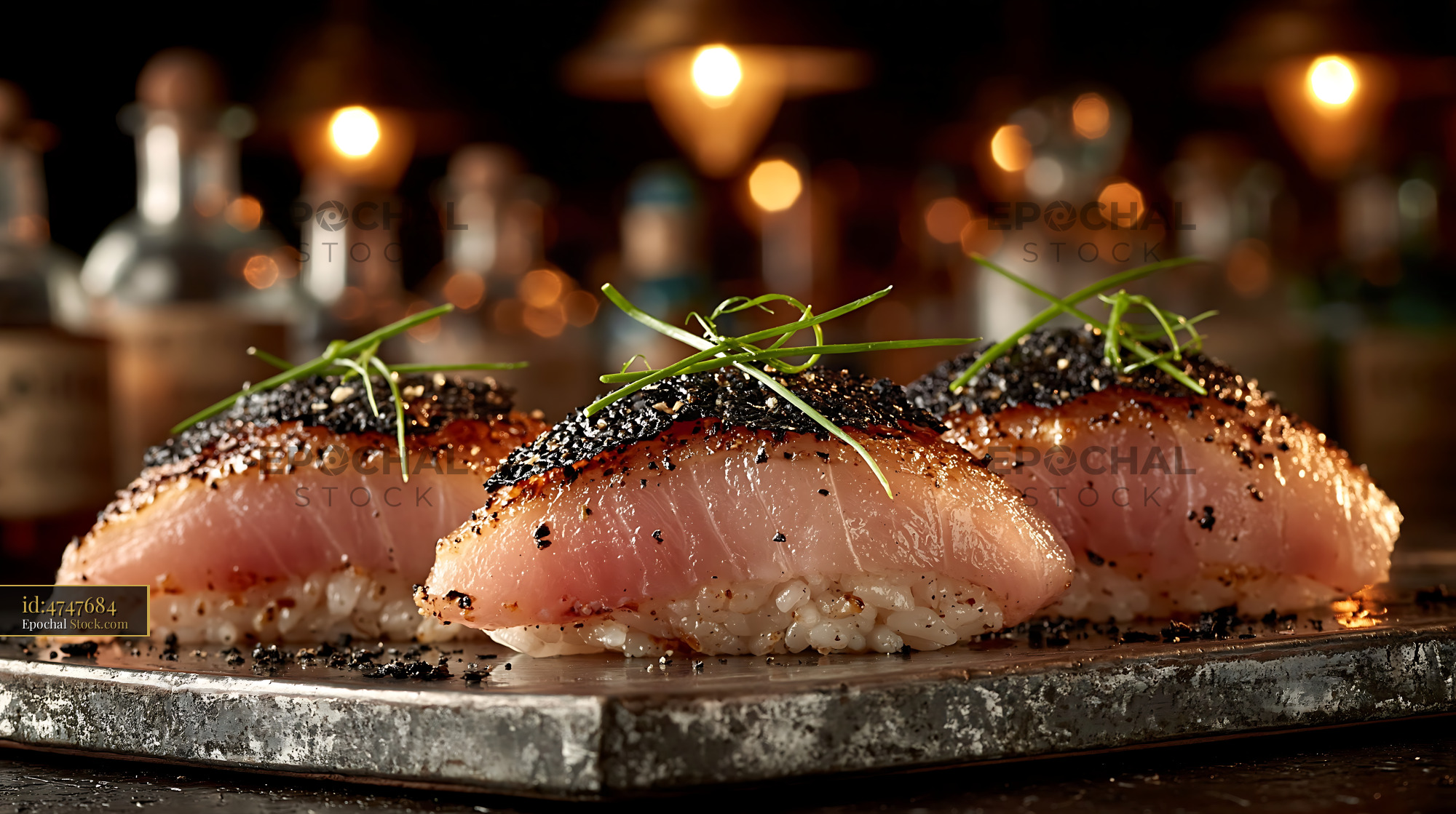 Foie gras nigiri sushi with seared crust and chives on stone plate - stock photo