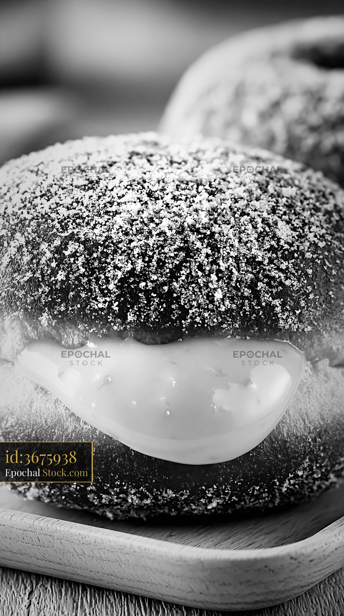 Fresh yuzu curd filled donut dusted with sugar in black and white - stock photo