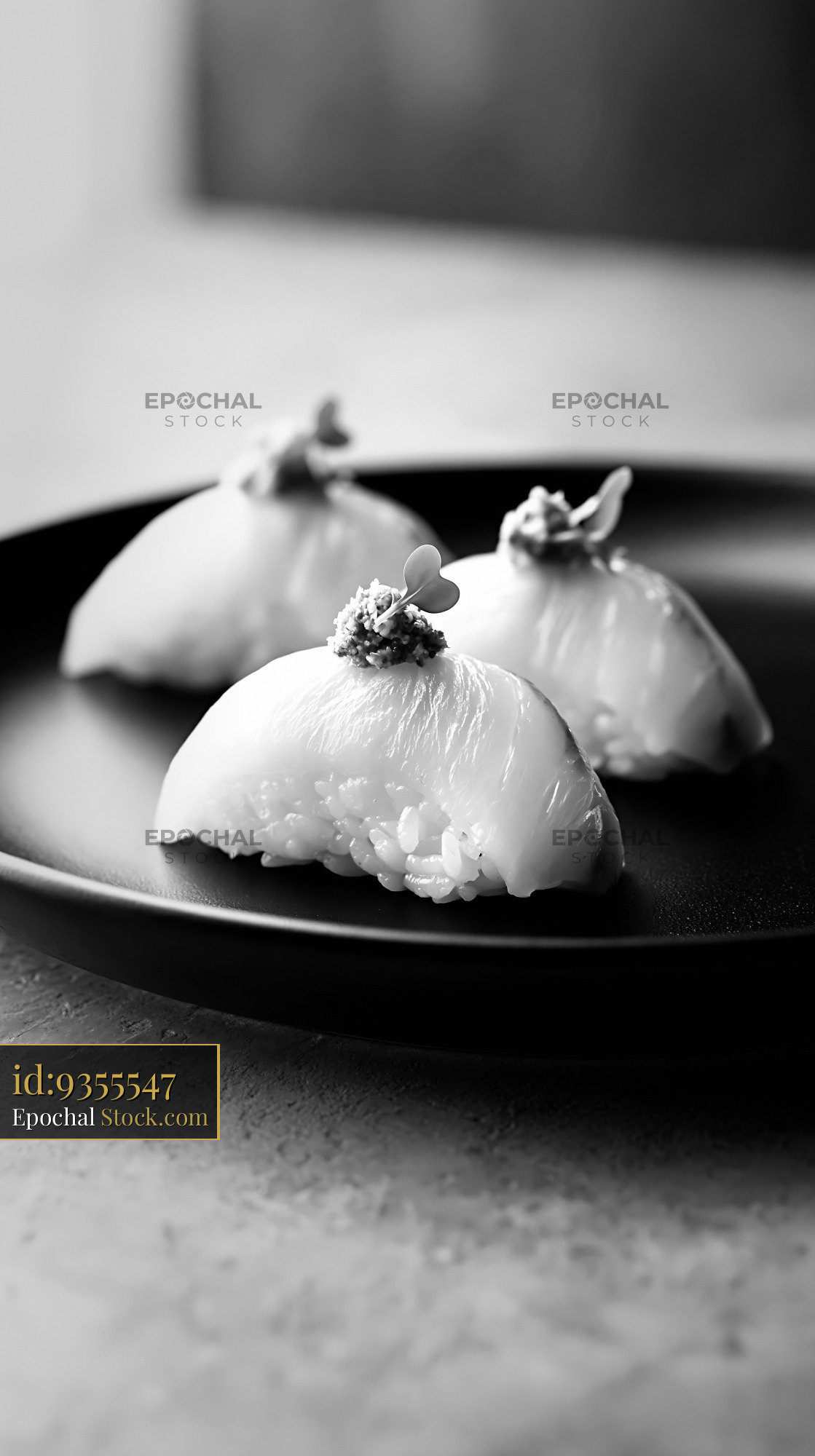 Gourmet yuzu kosho yellowtail sushi served on a dark matte plate - stock photo