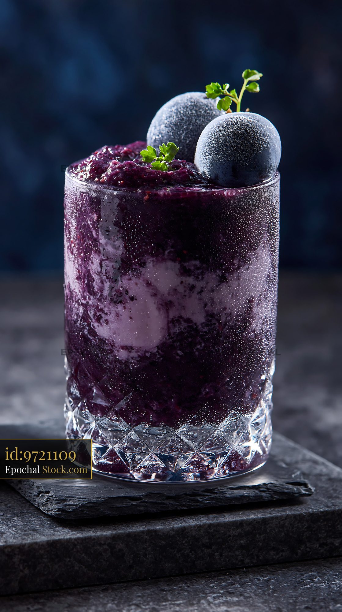 Chilled kyoho grape smoothie topped with frosted fruit in crystal glas - stock photo