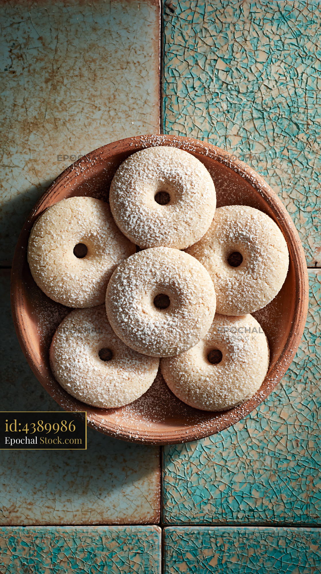Mahlab spice biscuits with powdered sugar on a rustic terracotta plate - stock photo