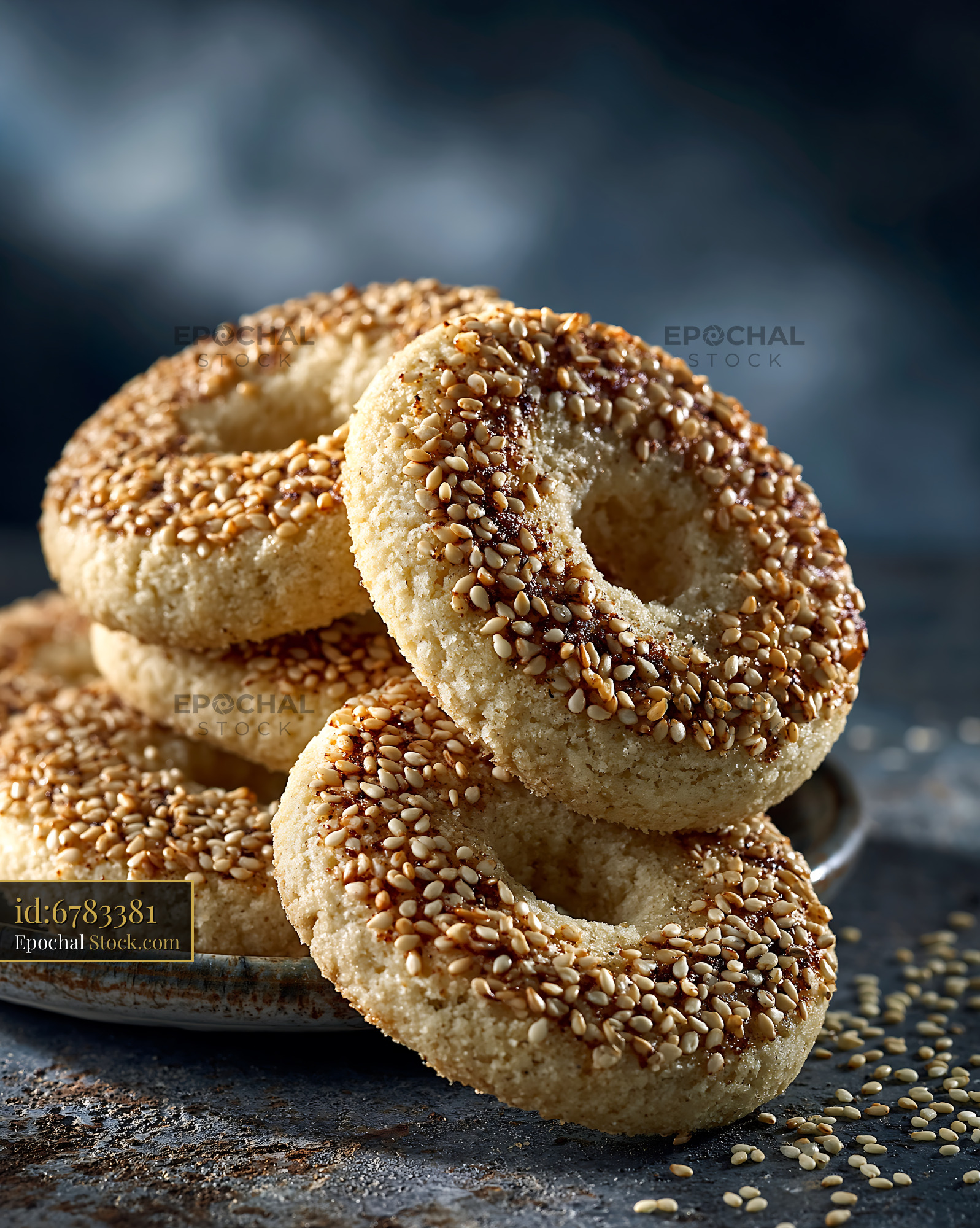 Mahlab spice biscuits with sesame seeds stacked on a rustic plate - stock photo