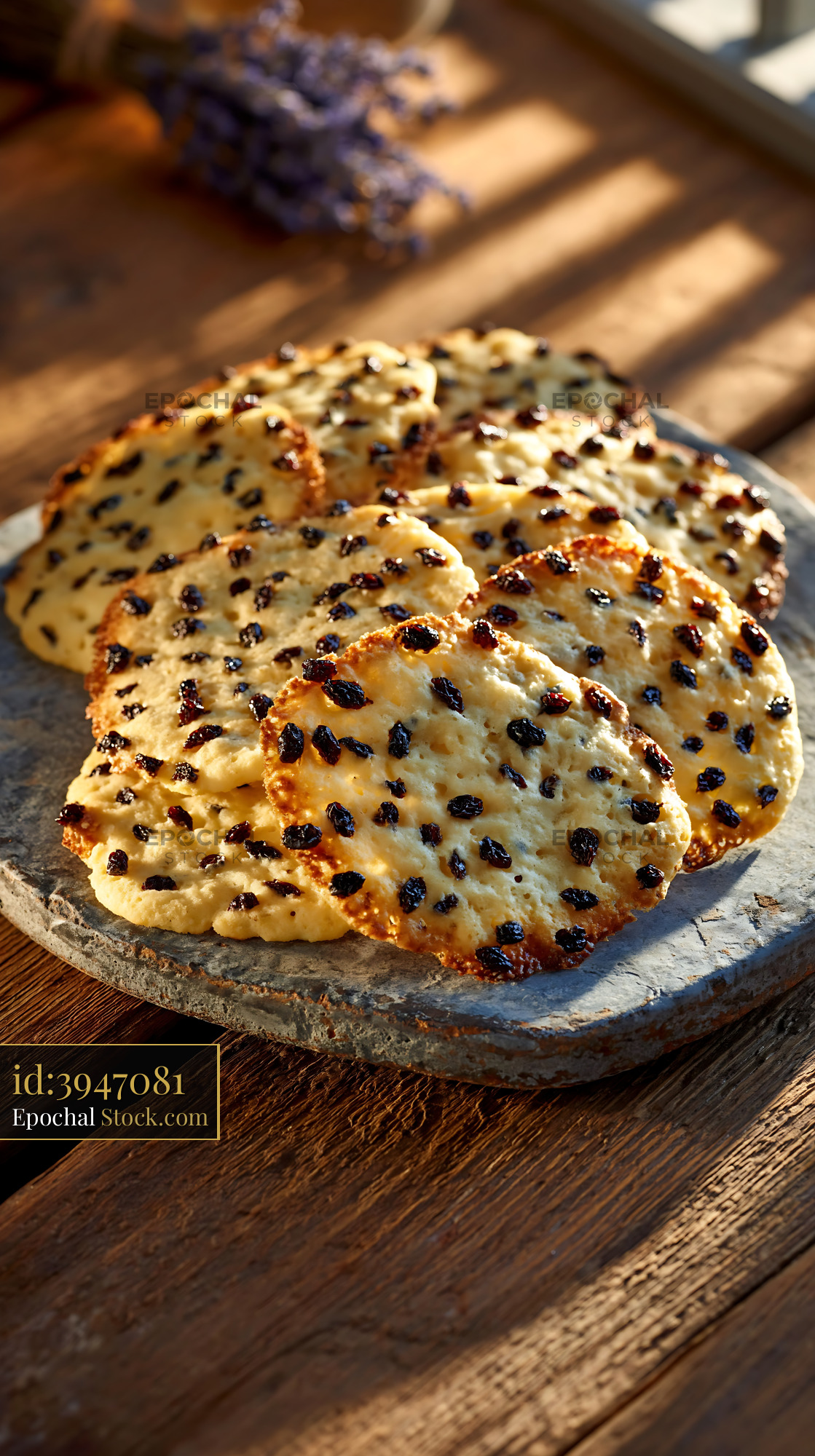 Traditional shirini kishmishi biscuits on stone plate in warm sunlight - stock photo
