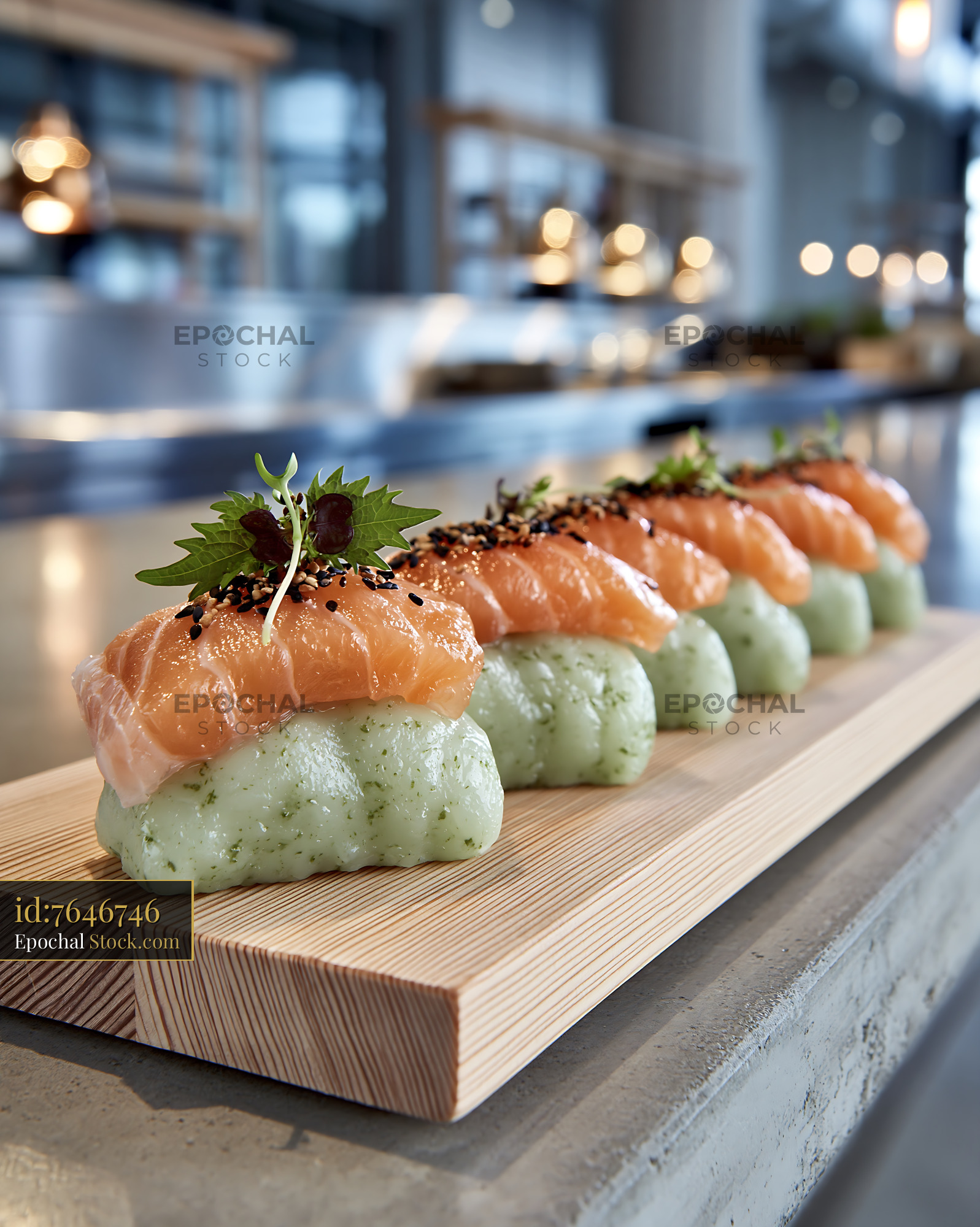Salmon nigiri with matcha infused rice served on a wooden board - stock photo