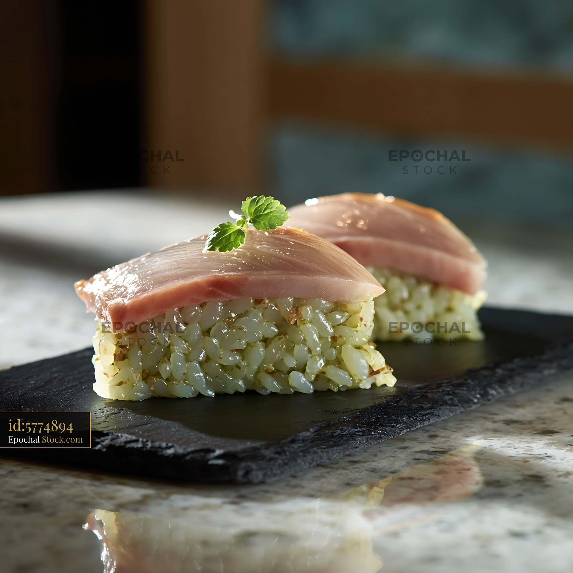 Matcha infused rice sushi with fresh fish on a black slate plate - stock photo
