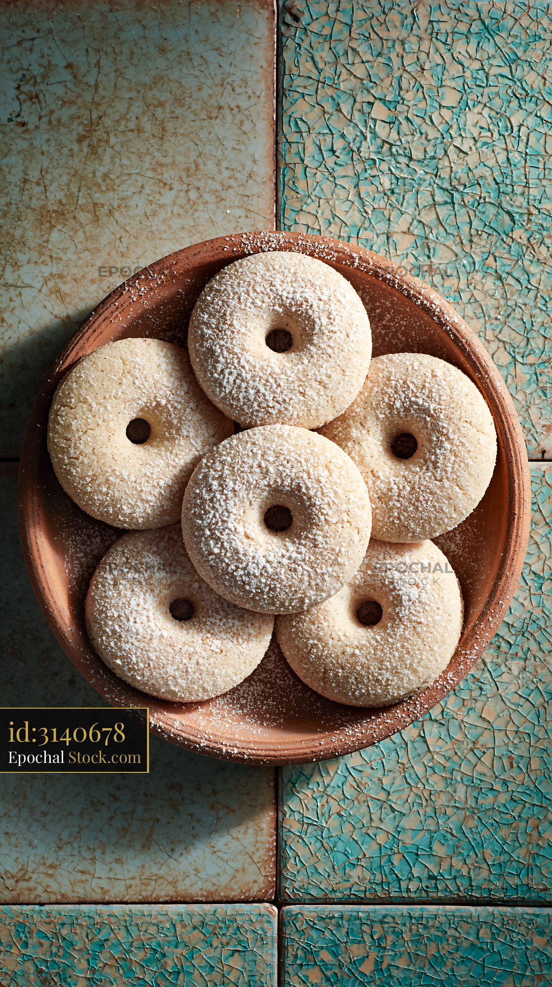 Mahlab spice biscuits with powdered sugar in a rustic clay bowl - stock photo