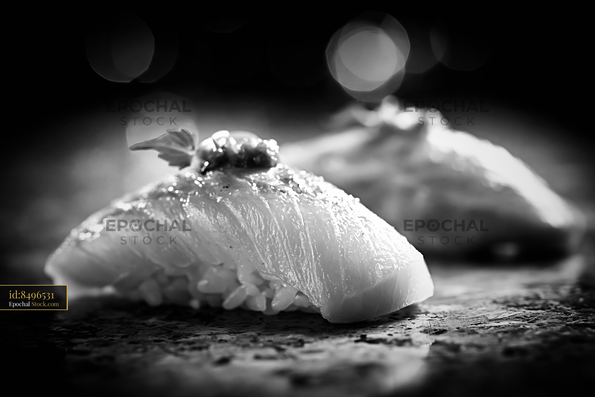 Yellowtail nigiri sushi with yuzu kosho garnish in black and white - stock photo