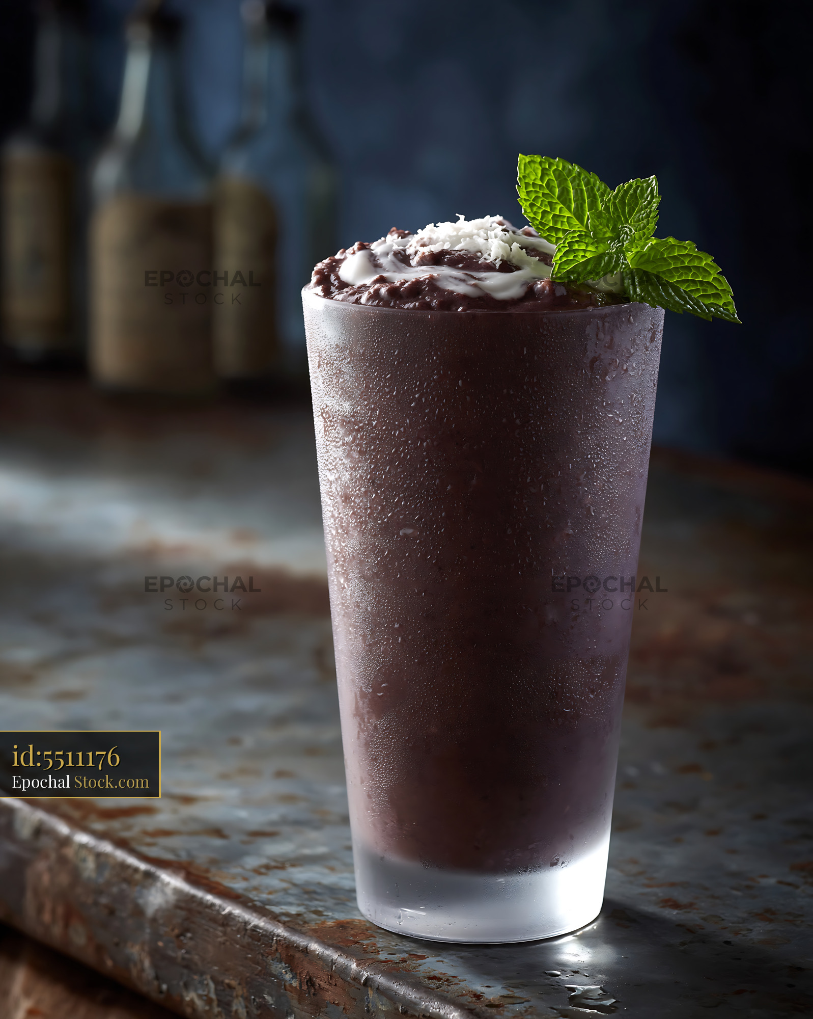 Black bean smoothie in a frosted glass with mint and coconut flakes - stock photo