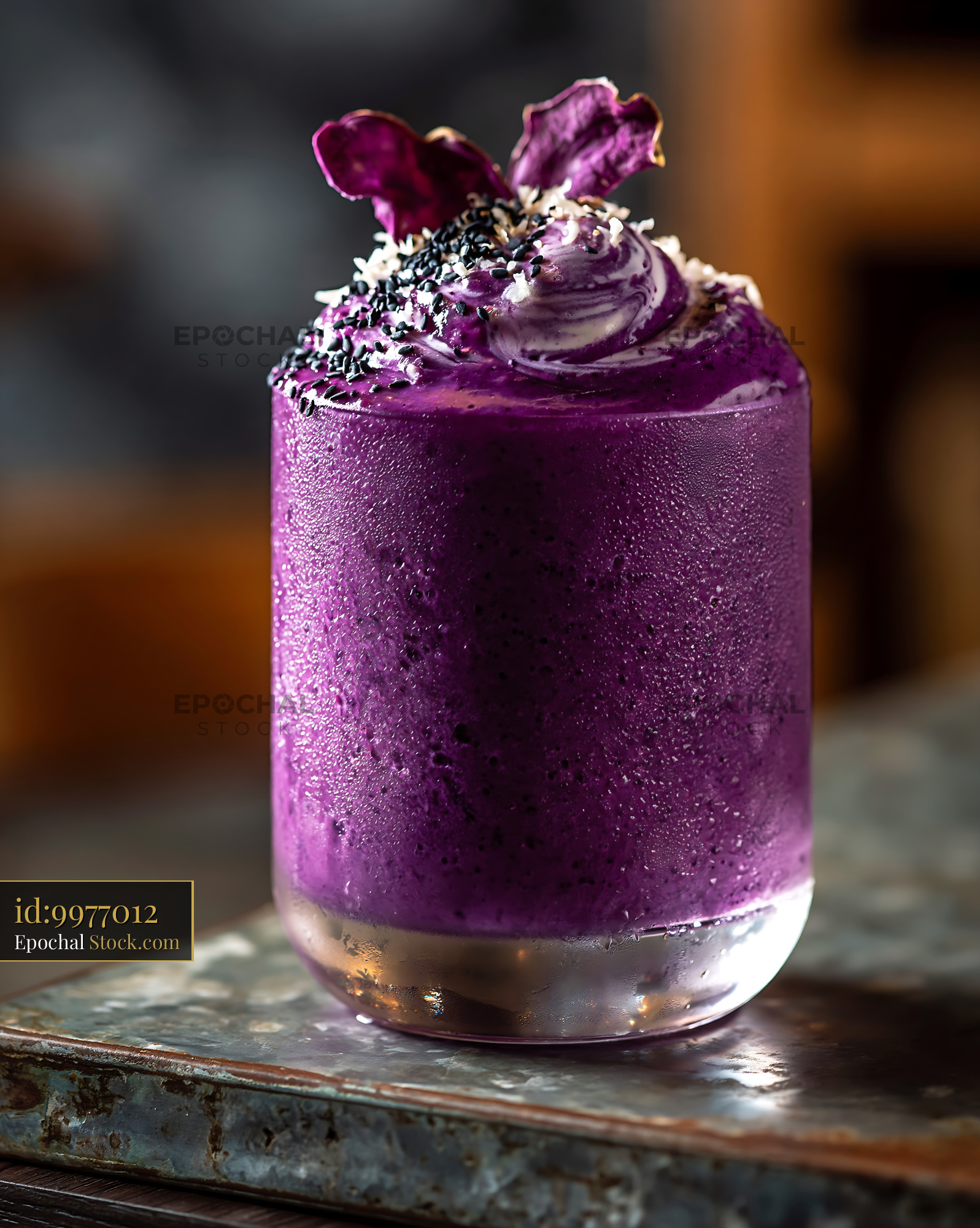 Vibrant purple beni imo smoothie topped with black sesame and chips - stock photo