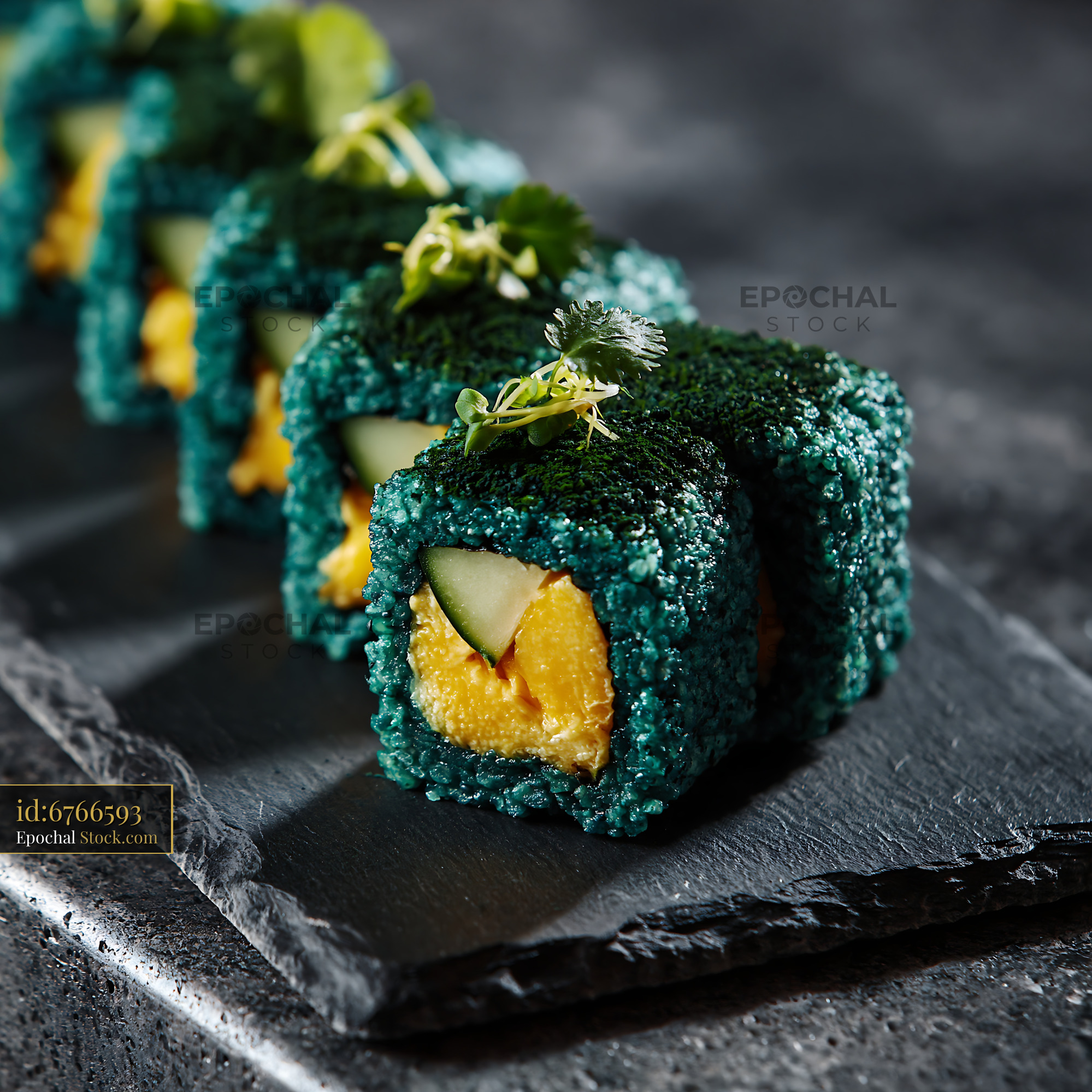 Gourmet sushi rolls with spirulina powder mango and cucumber - stock photo