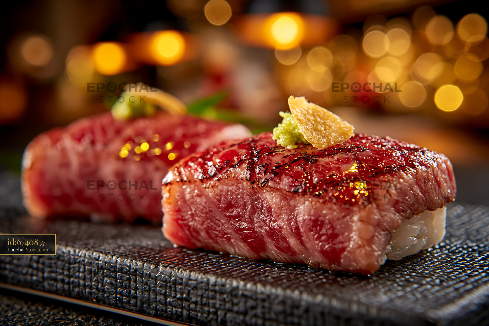 Aburi wagyu sushi with seared beef and wasabi in warm lighting - stock photo
