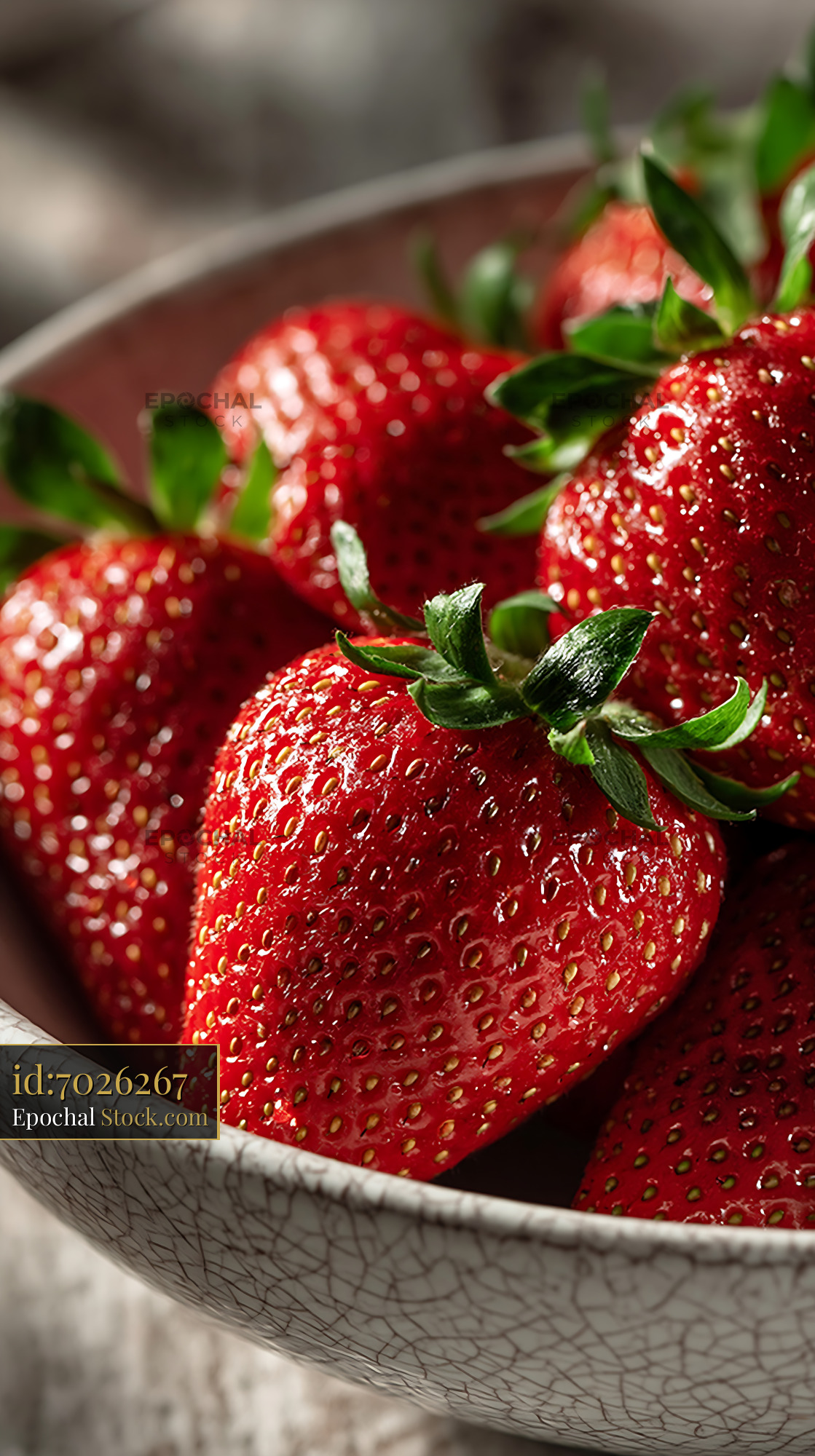 Fresh strawberries in a rustic ceramic bowl with crackled glaze - stock photo