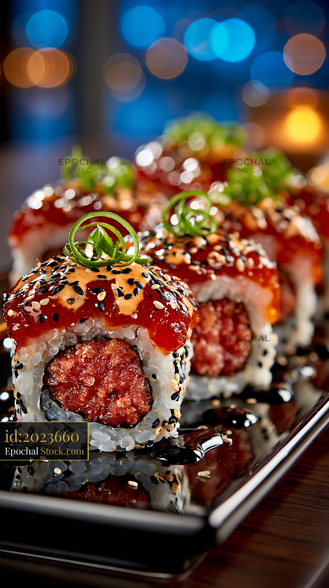 Sriracha mayo tuna sushi rolls with spicy tuna and scallion garnish - stock photo