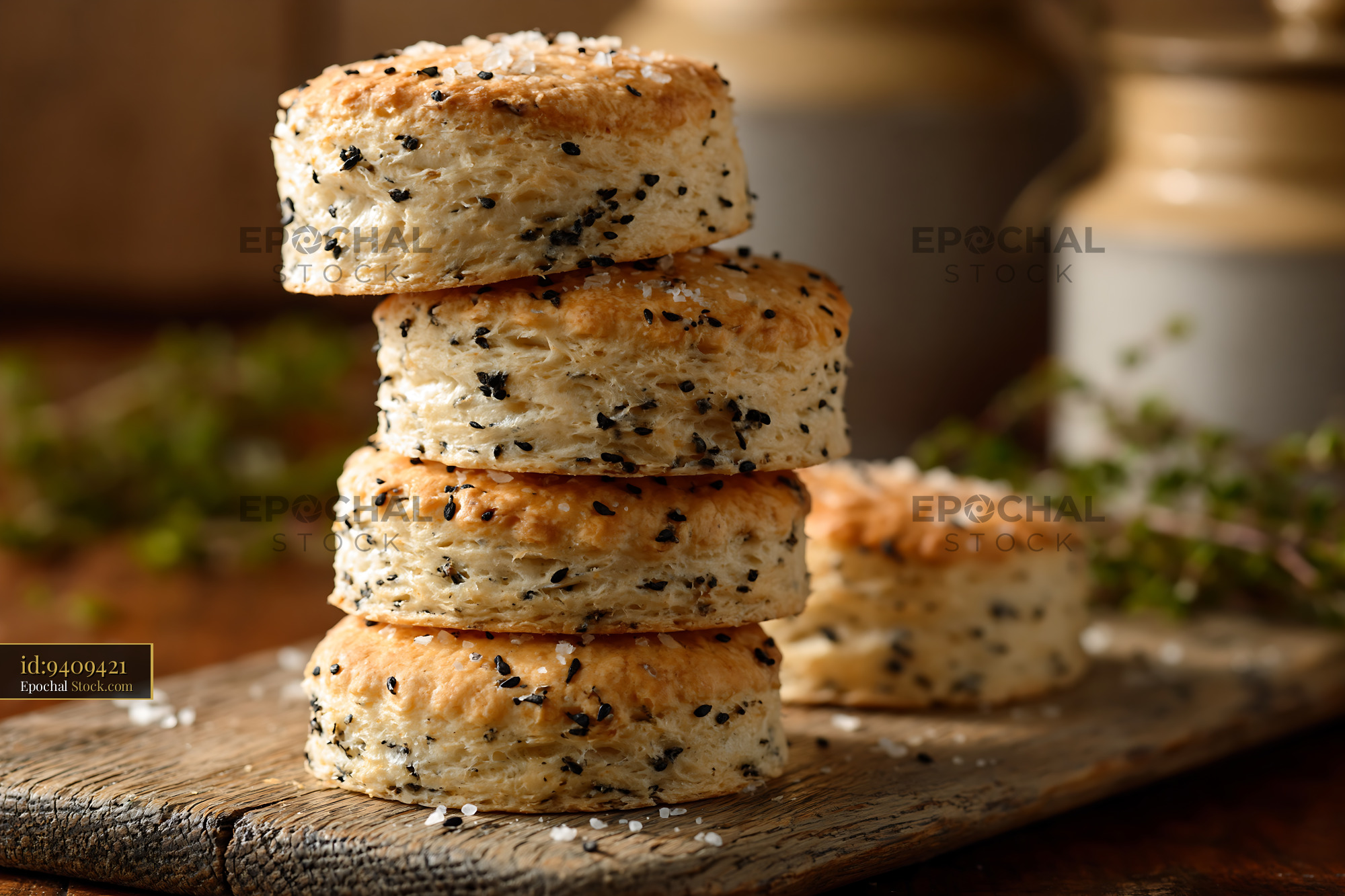 Stack of fresh nigella seed biscuits on a rustic wooden board - stock photo