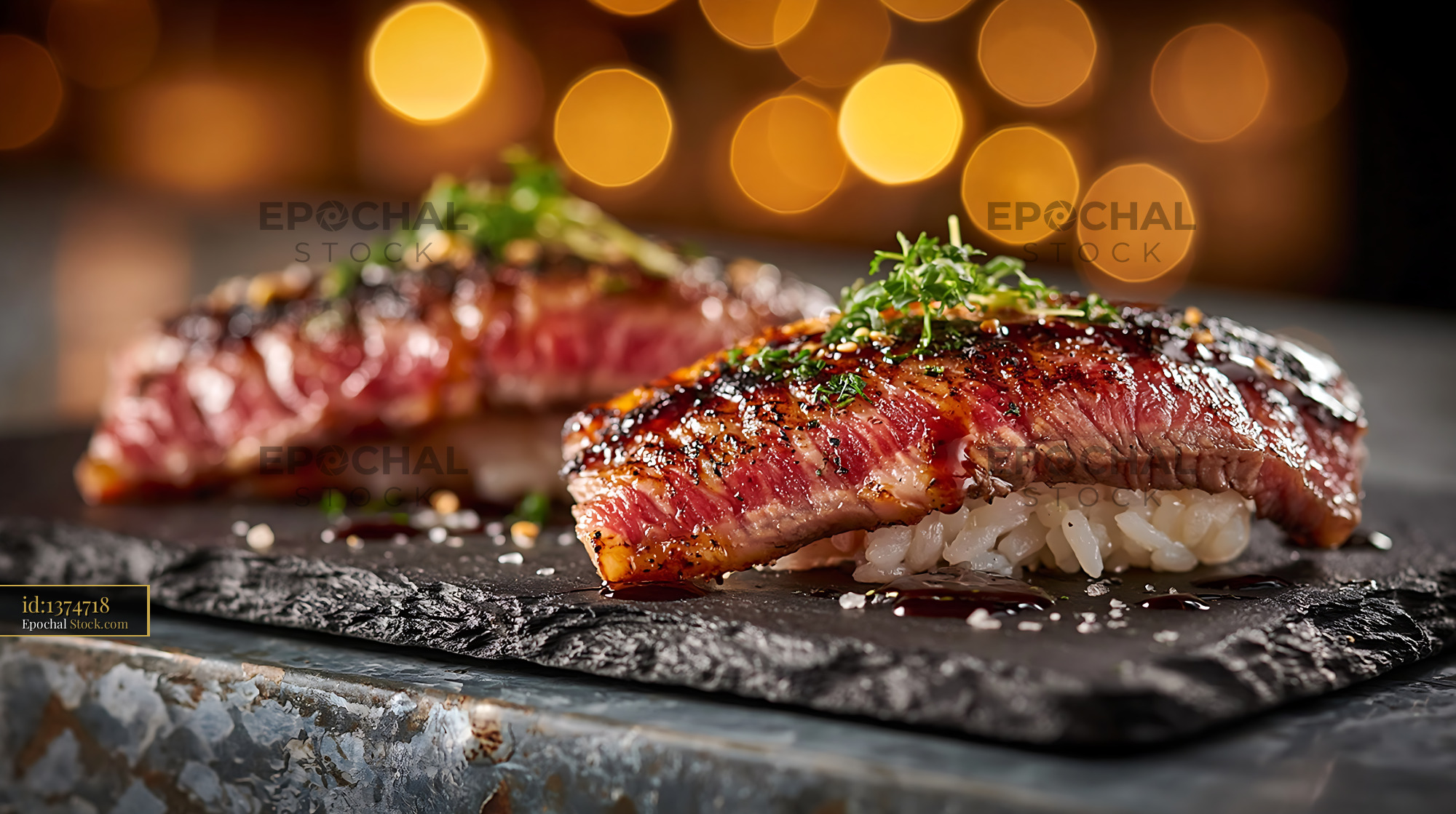 Gourmet aburi wagyu sushi on a slate plate with warm bokeh lights - stock photo
