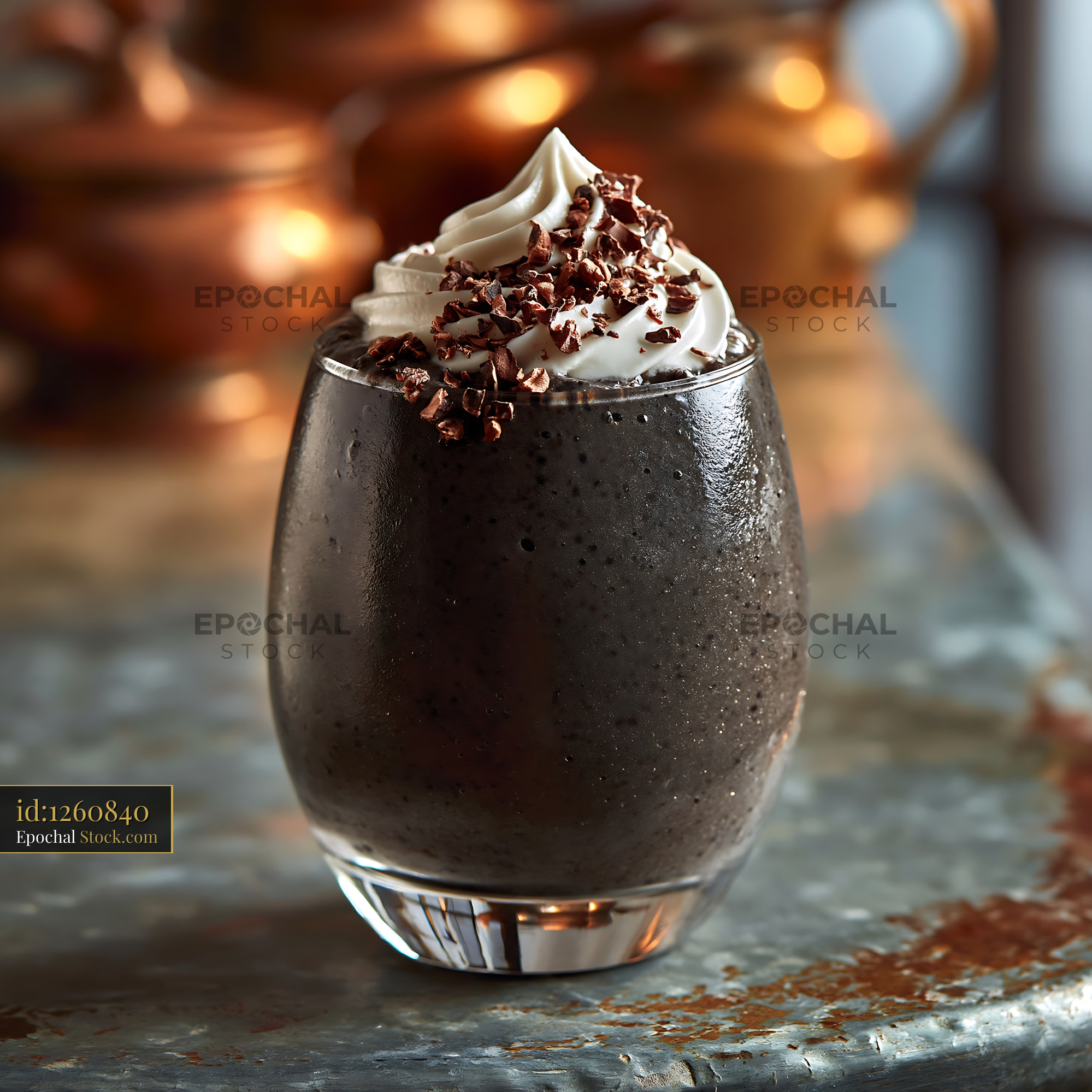 Black bean smoothie with whipped cream and cocoa nibs on rustic table - stock photo