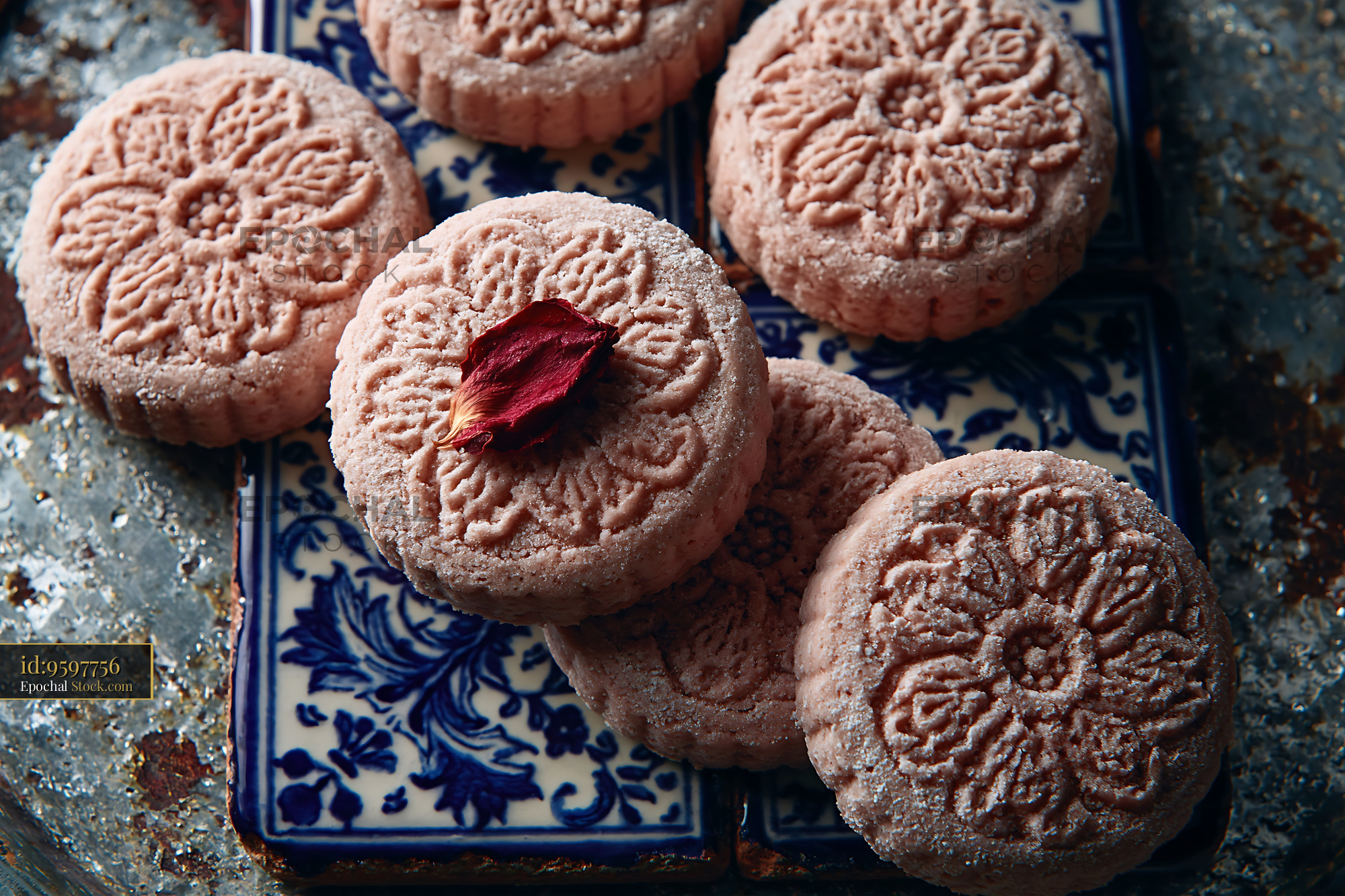 Rose water biscuits with floral patterns on blue ceramic tiles - stock photo