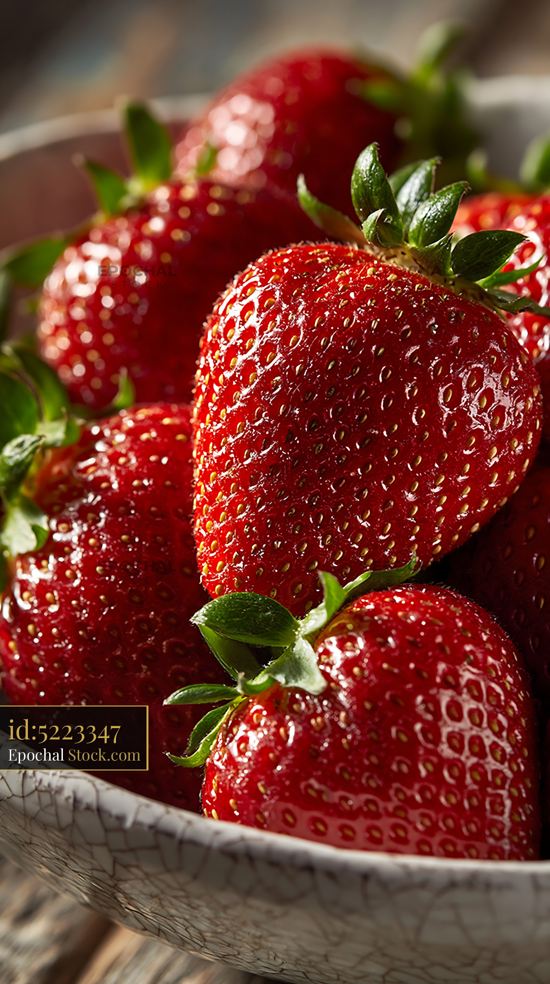 Fresh red strawberries in a white ceramic bowl with rustic glaze - stock photo