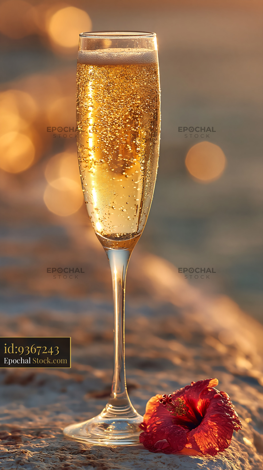 Chilled glass of lemonade with ice cubes and hibiscus at sunset - stock photo