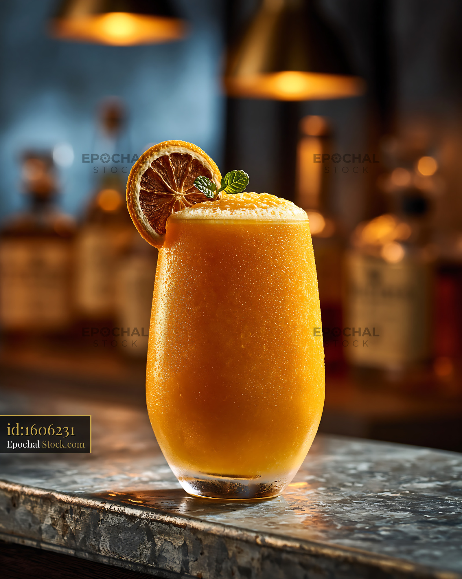 Hallabong citrus smoothie with mint garnish on a rustic bar counter - stock photo