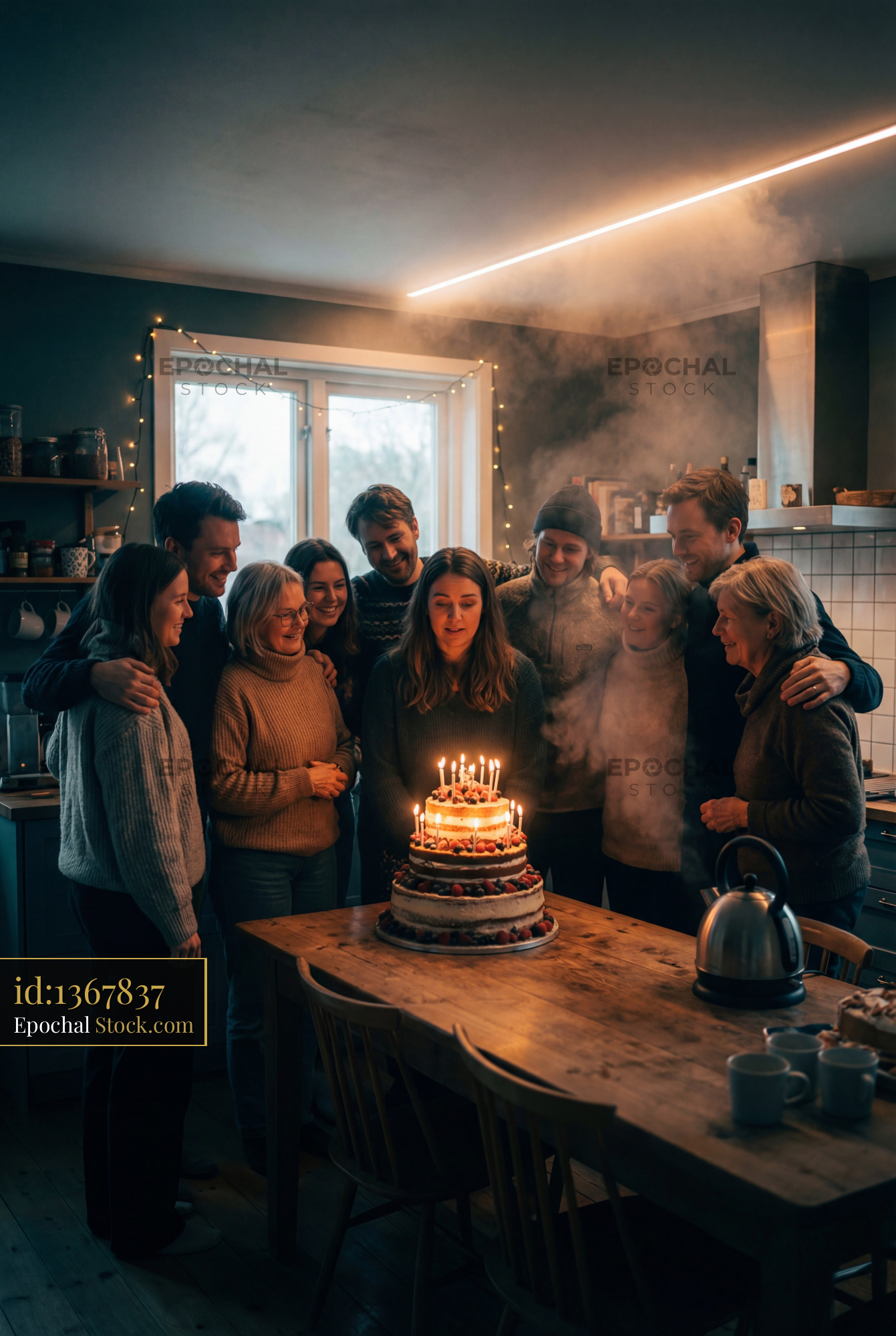Birthday celebration with friends and family in a cozy kitchen - stock photo