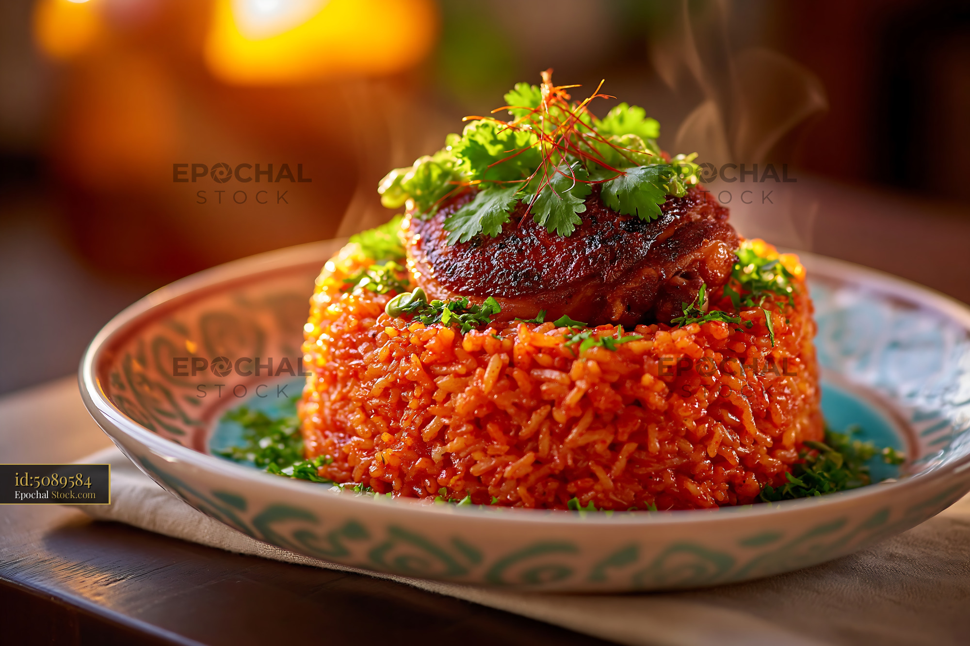 Gourmet Jollof rice topped with roasted chicken and fresh herbs - stock photo