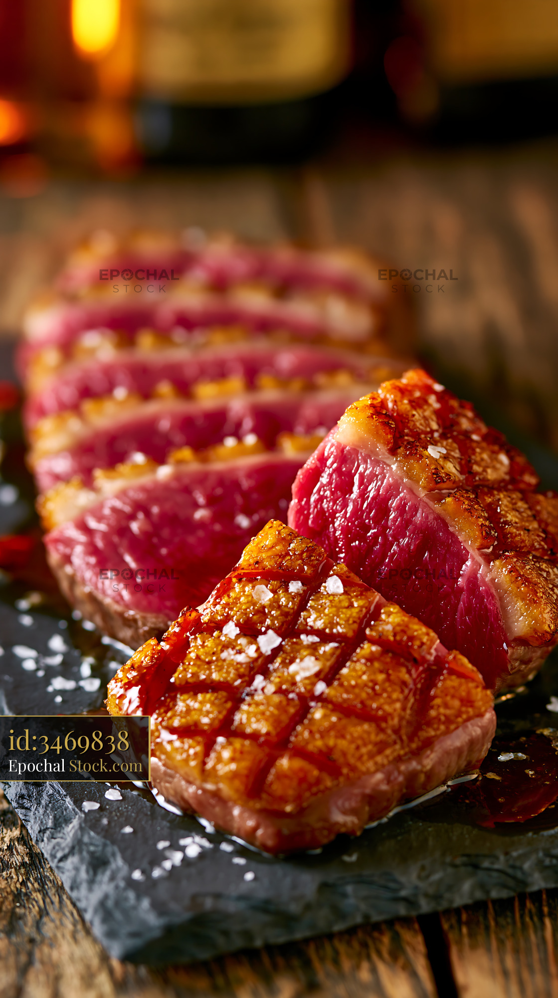 Sliced roasted magret de canard meat with crispy skin on slate board - stock photo