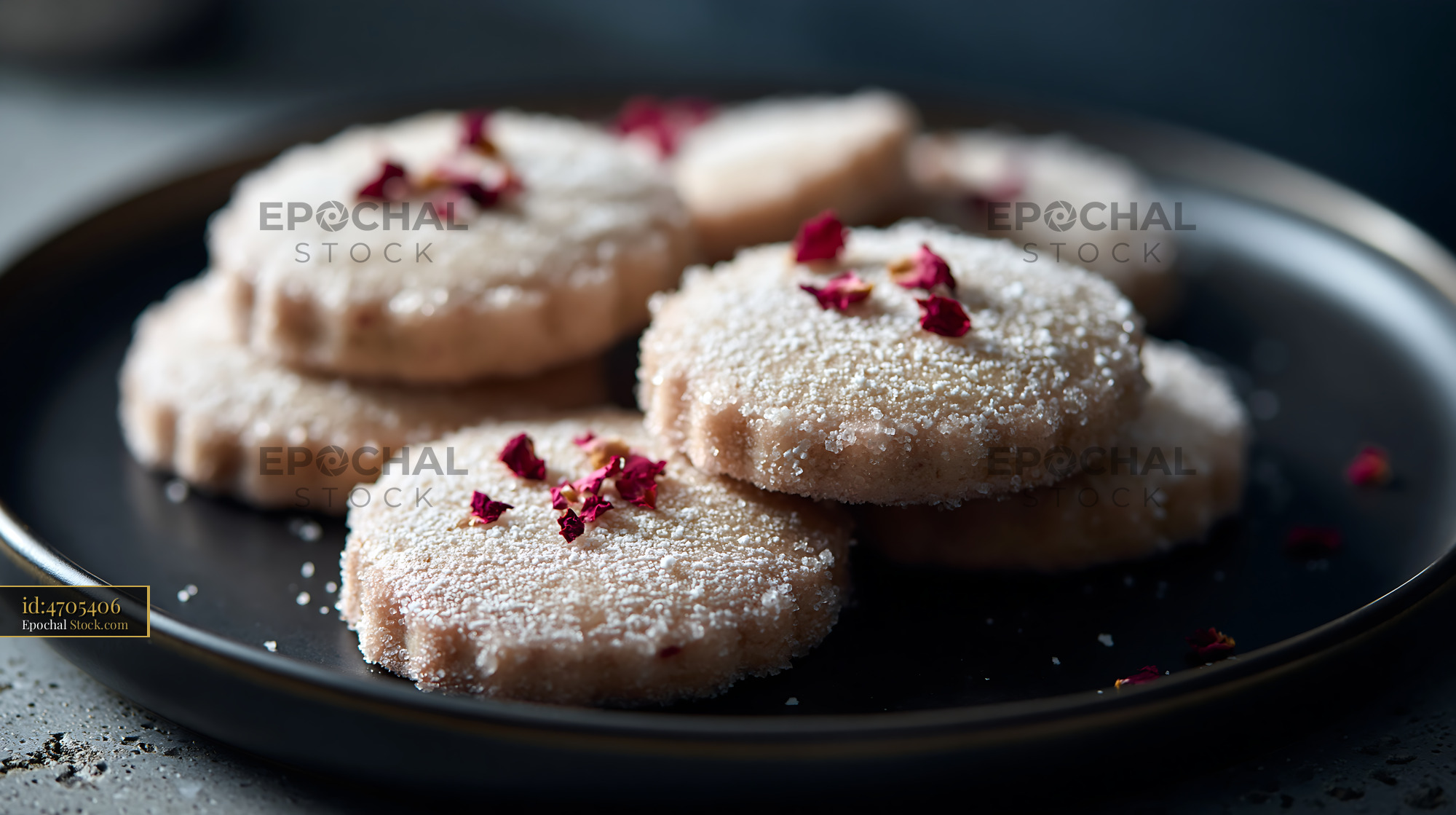 Rose water biscuits with sugar dusting and dried rose petals on a plat - stock photo