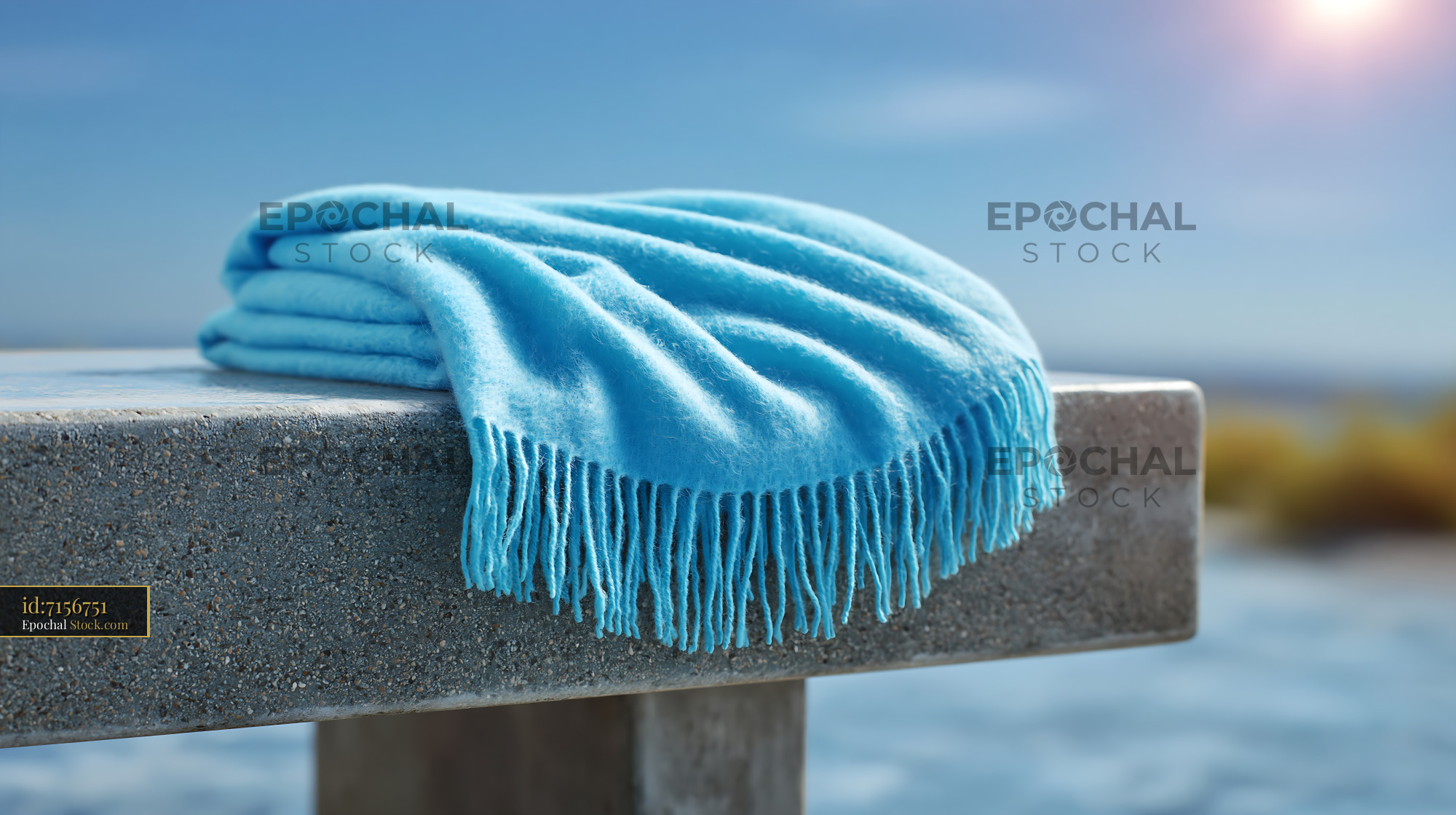 Soft blue cottage garden bench blanket on a sunny stone seat