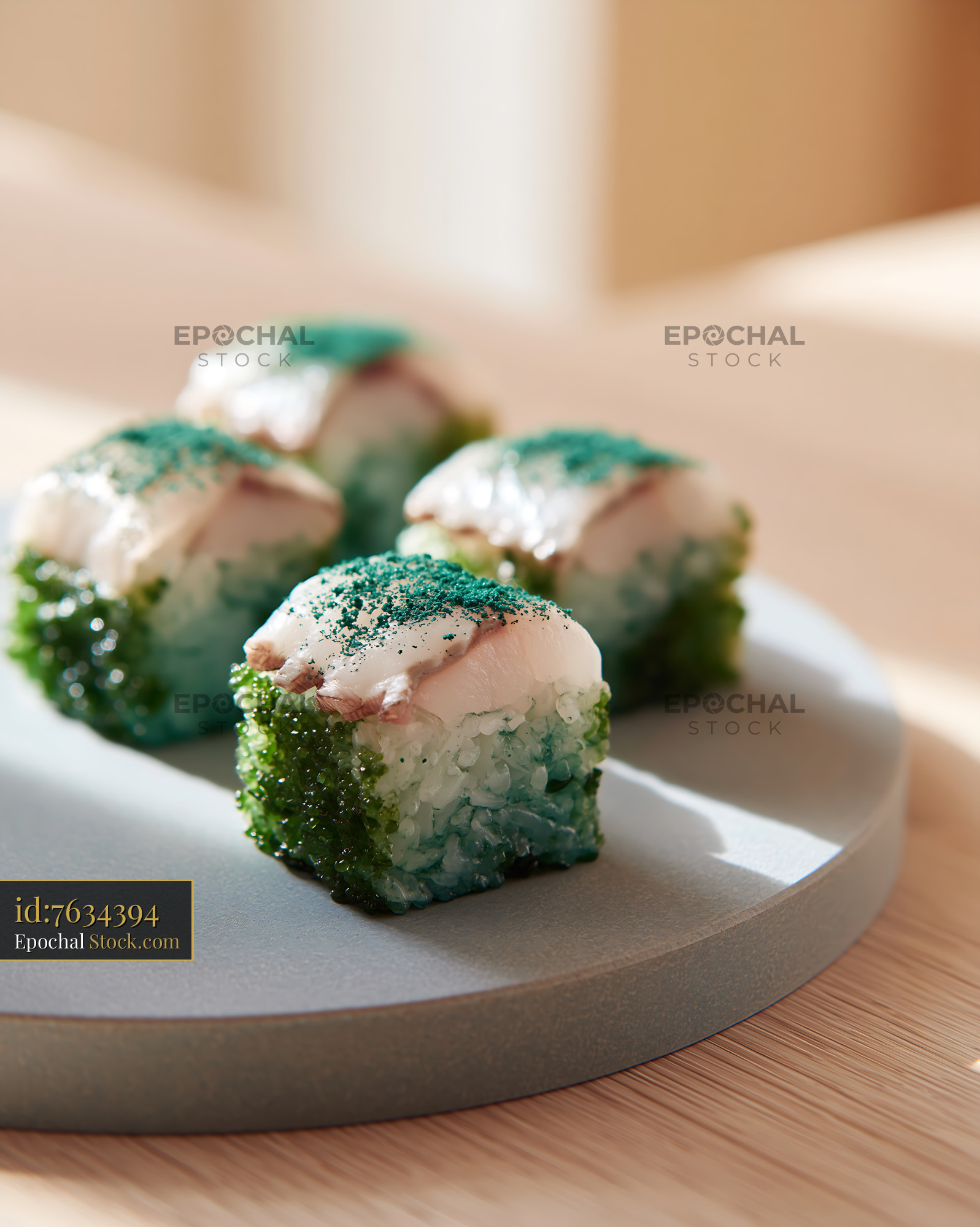 Modern sushi cubes with white fish and green spirulina powder - stock photo