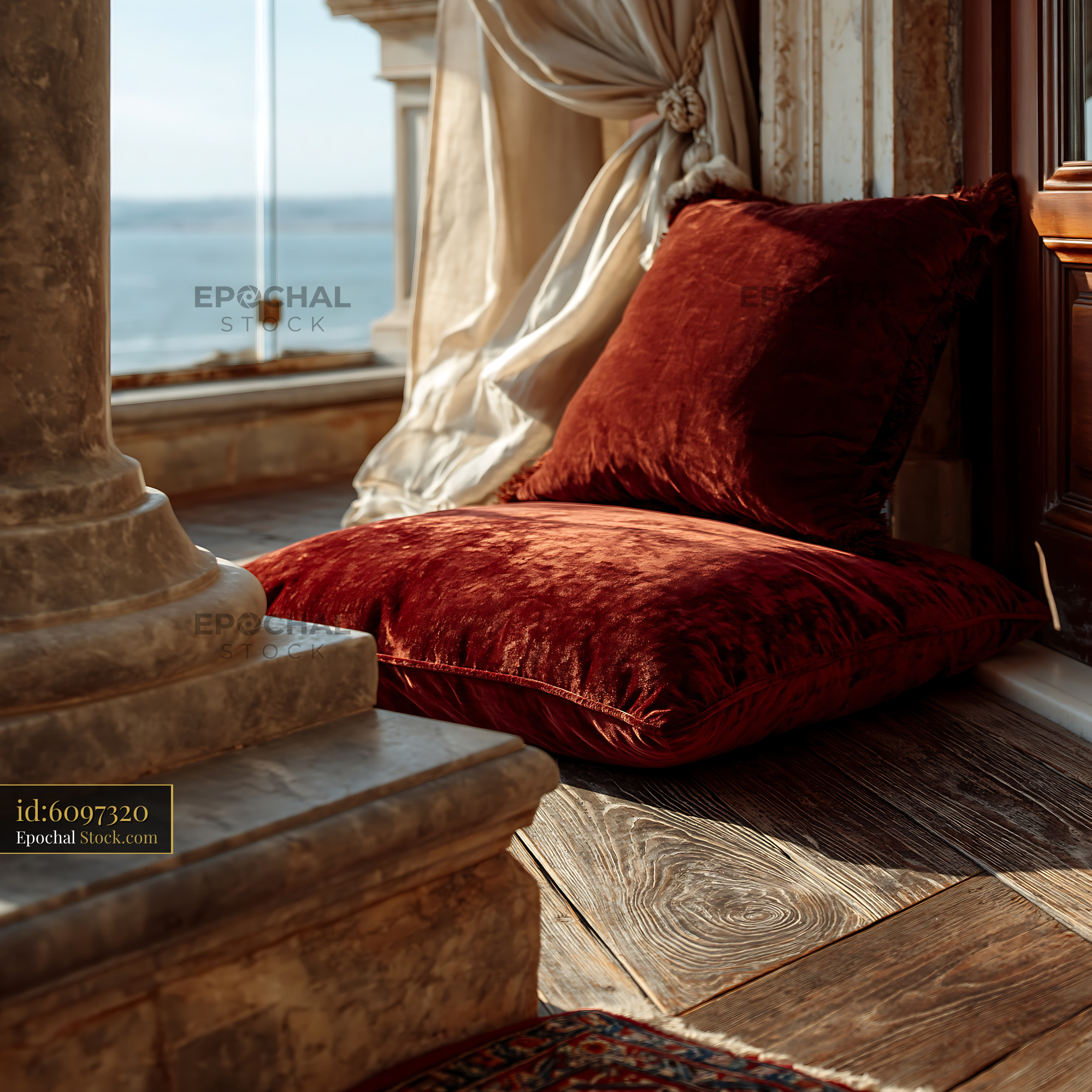 Red velvet pillows on a luxury hotel balcony with sea view - stock photo