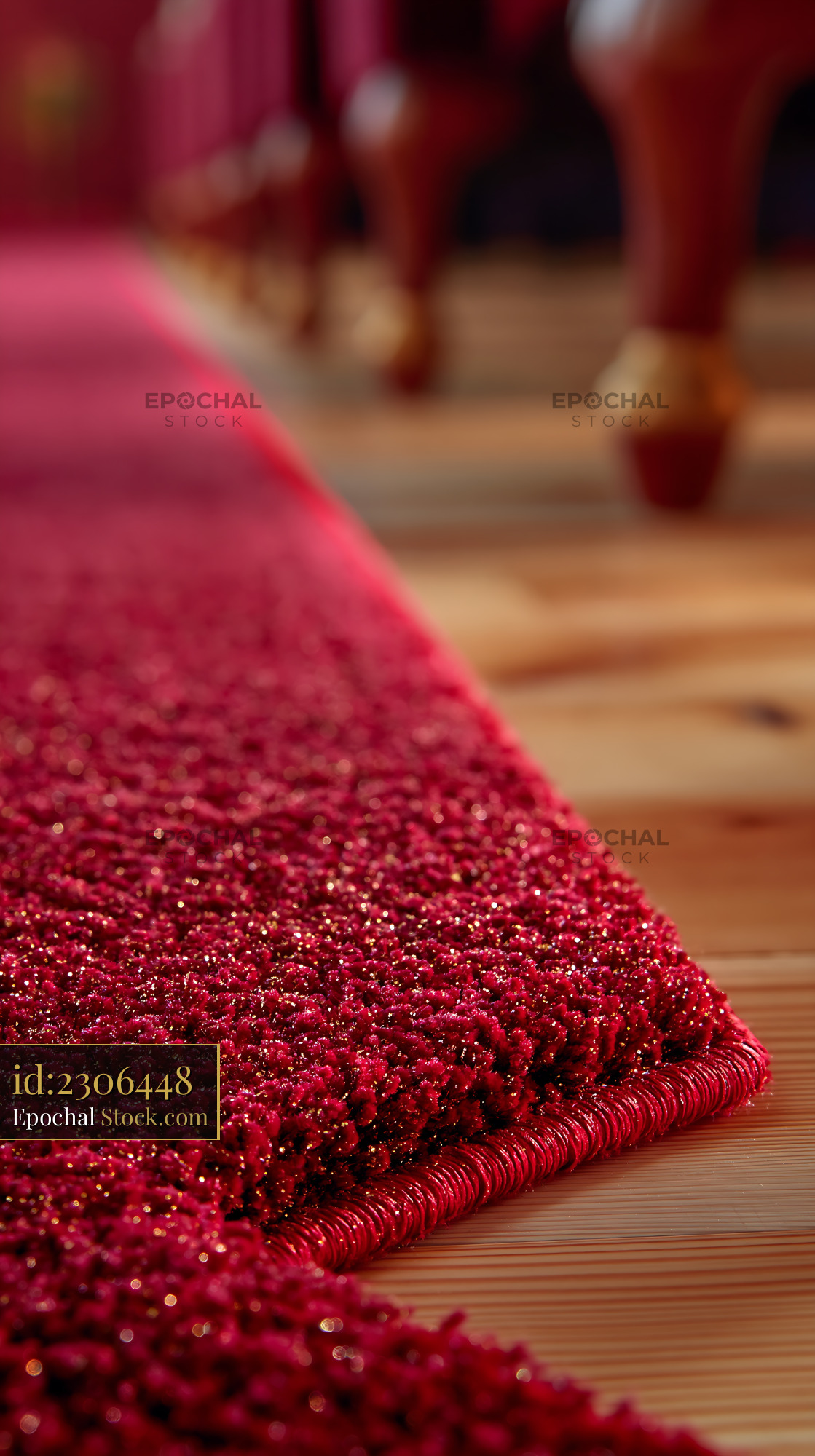 Close up of a red carpet on wooden floor in an empty stage room - stock photo