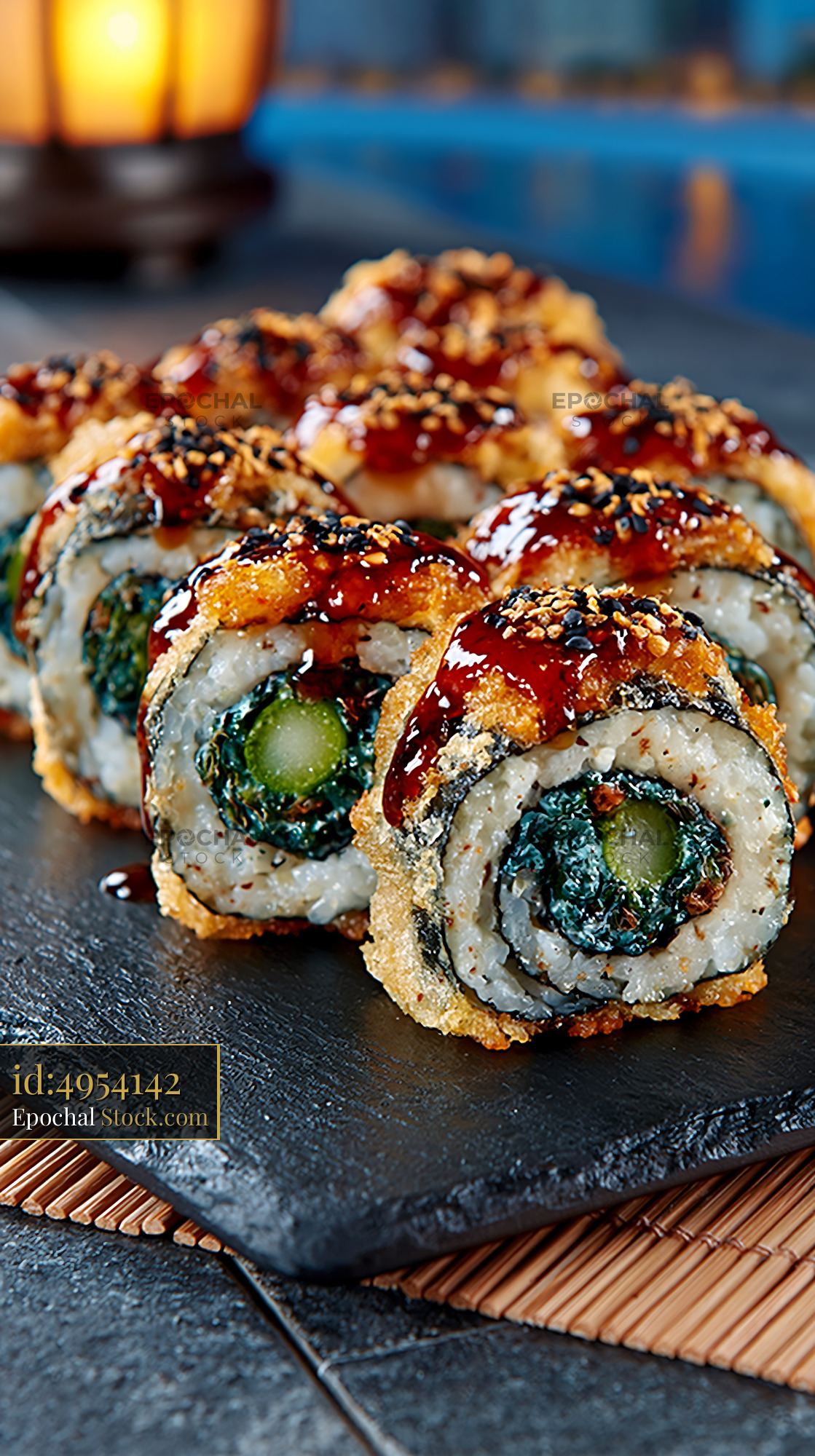 Crispy tempura asparagus sushi rolls with sweet glaze on slate plate - stock photo