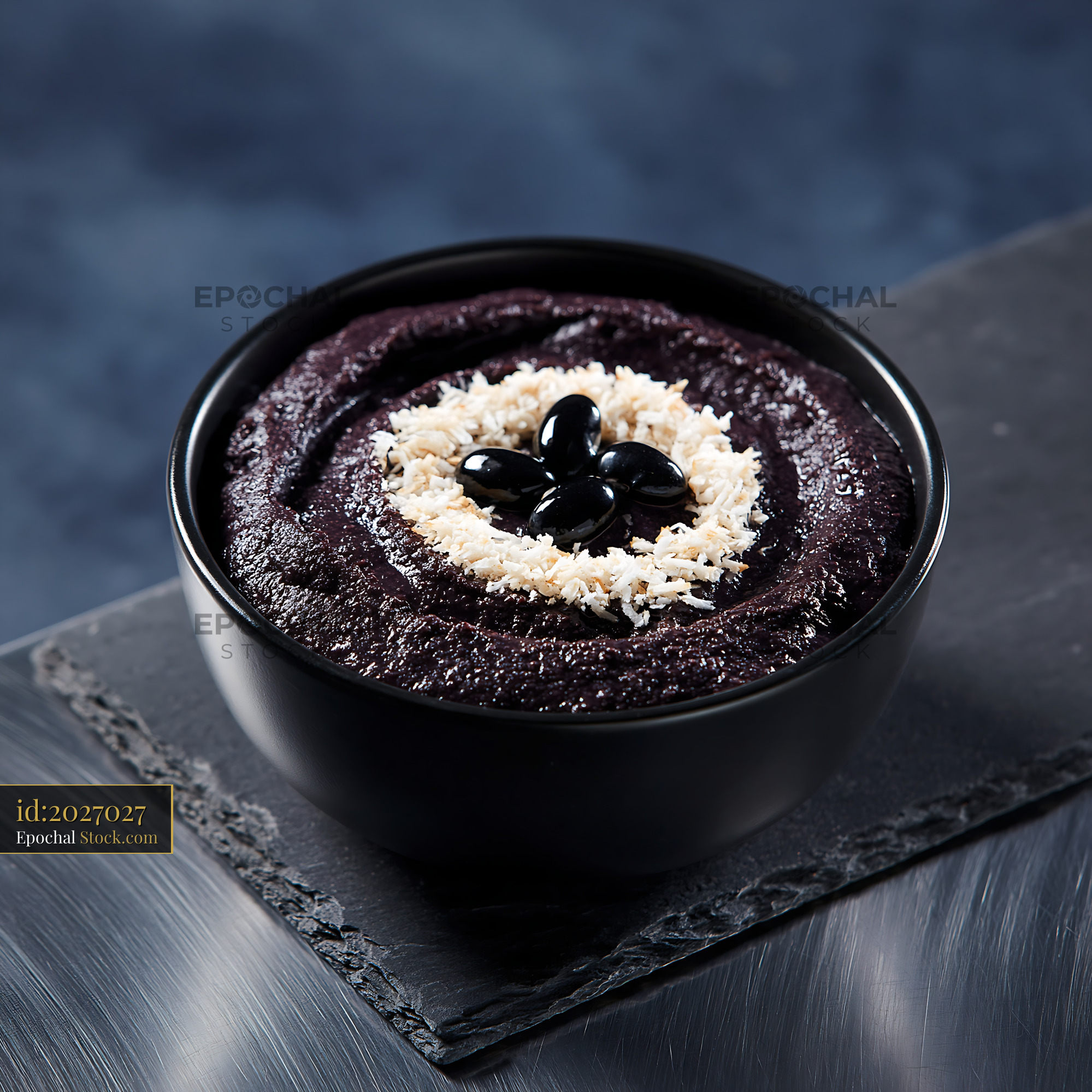 Healthy black bean smoothie bowl topped with shredded coconut - stock photo