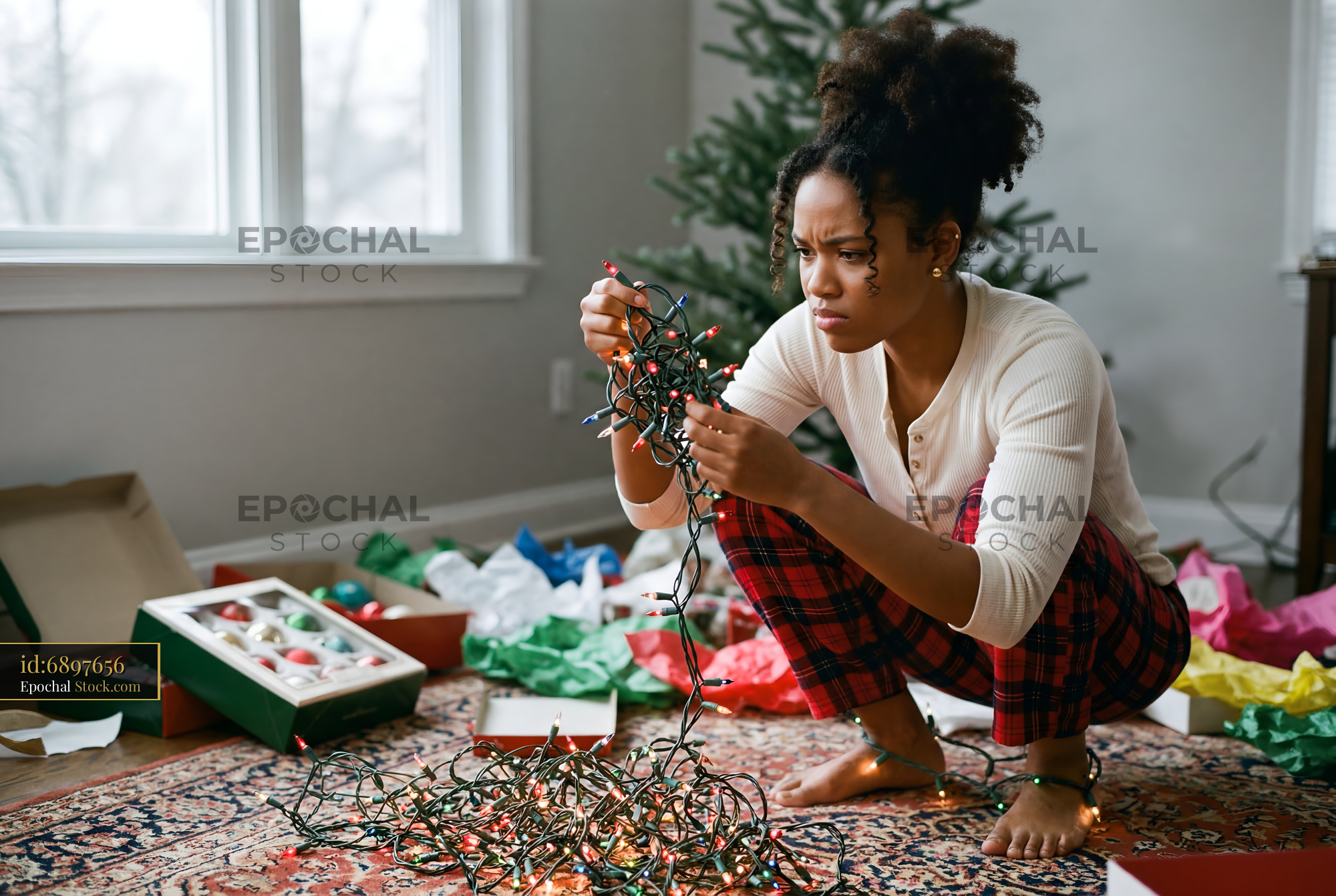 Woman organizing Christmas lights in living room at home Premium Stock Photo - stock photo