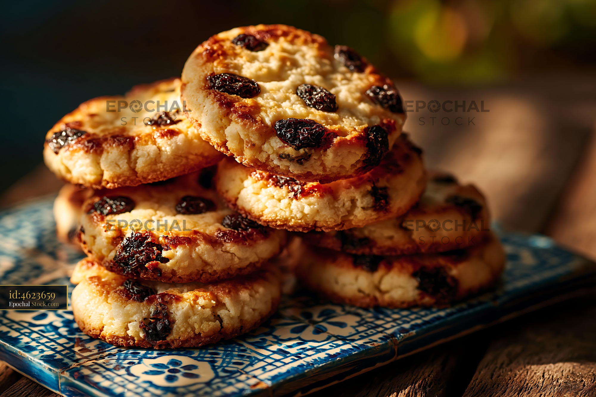 Stack of dibs el kharroub biscuits on a traditional blue tile - stock photo