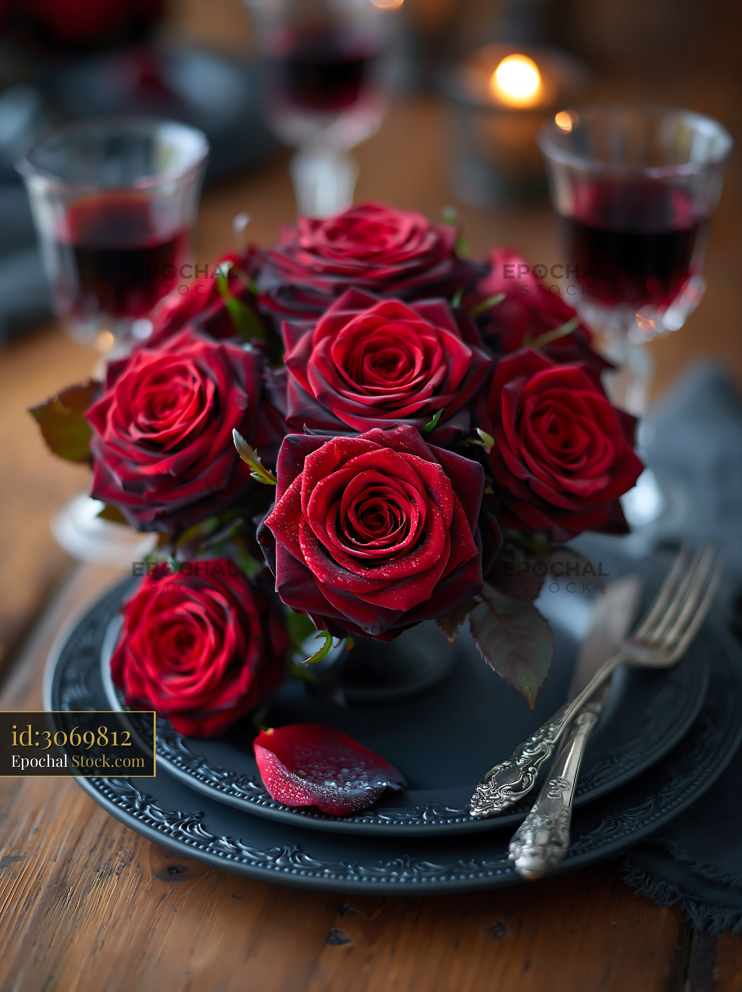 Gala dinner table with red roses on elegant black plates - stock photo