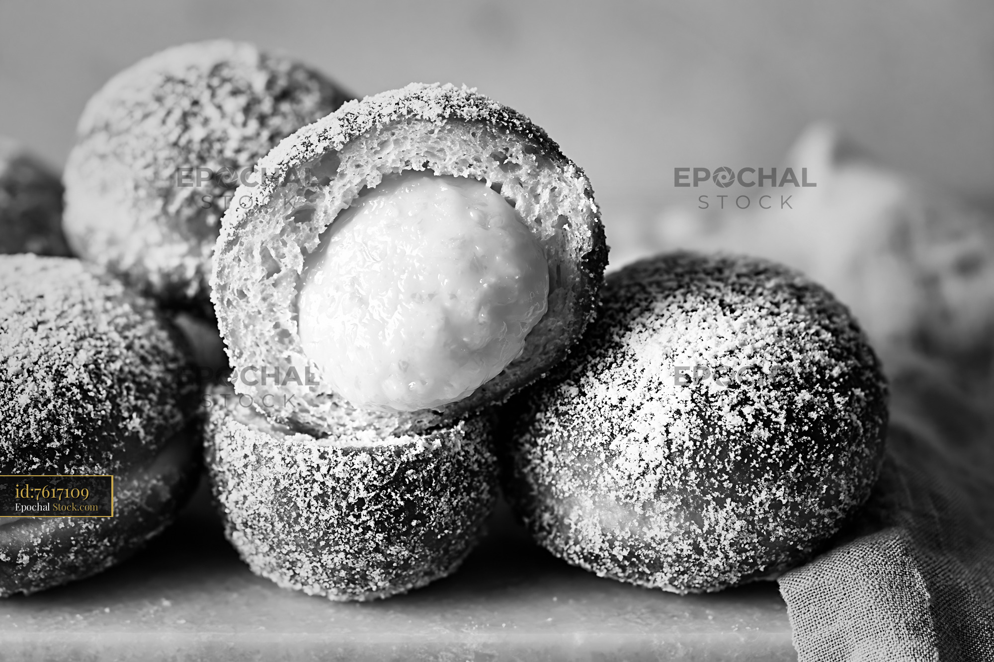 Fresh yuzu curd filled donuts with sugar coating in black and white - stock photo