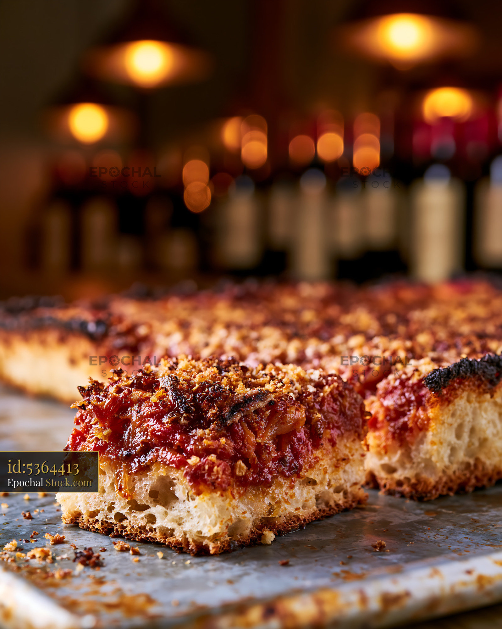 Traditional sfincione pizza slice with thick crust and tomato sauce - stock photo